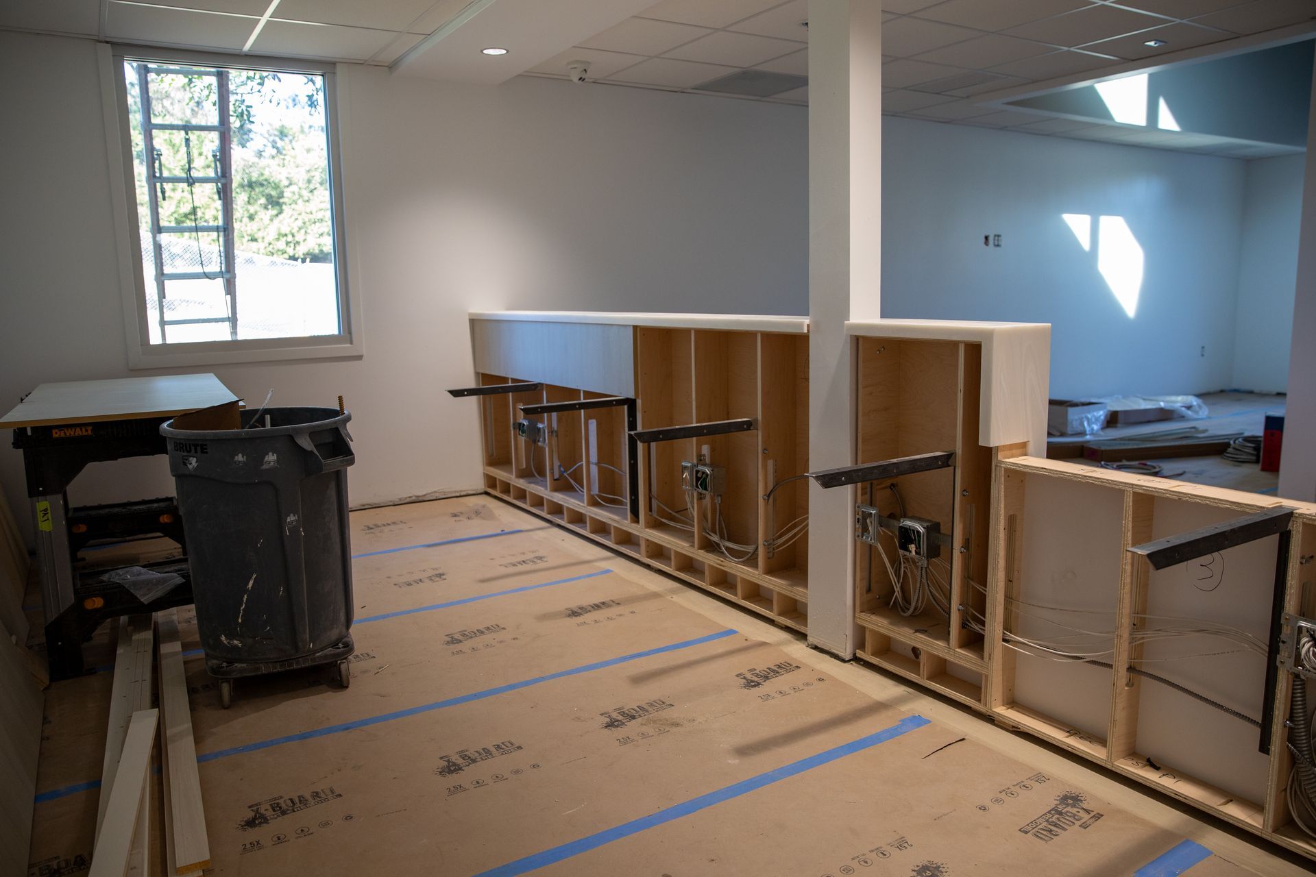A room with a lot of cabinets and a window