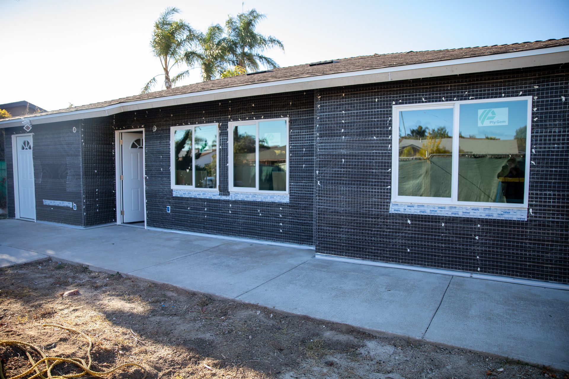 A house with a lot of windows is being built.