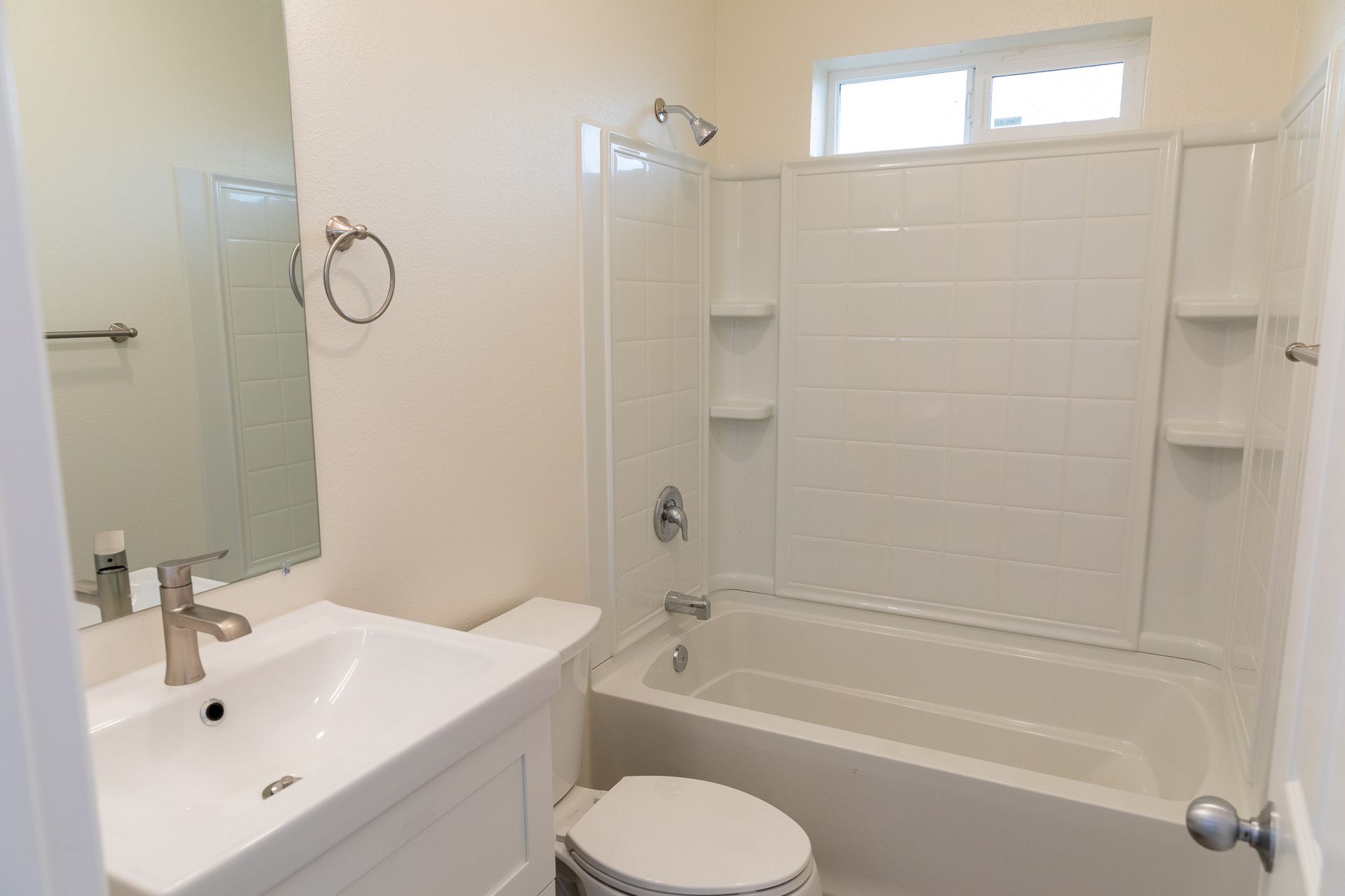 A bathroom with a toilet a sink and a bathtub