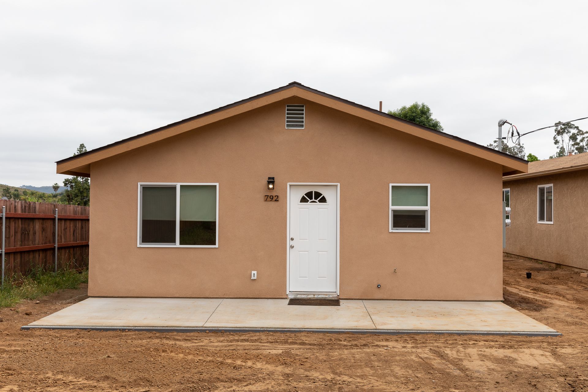 A brown house with a white door and windows