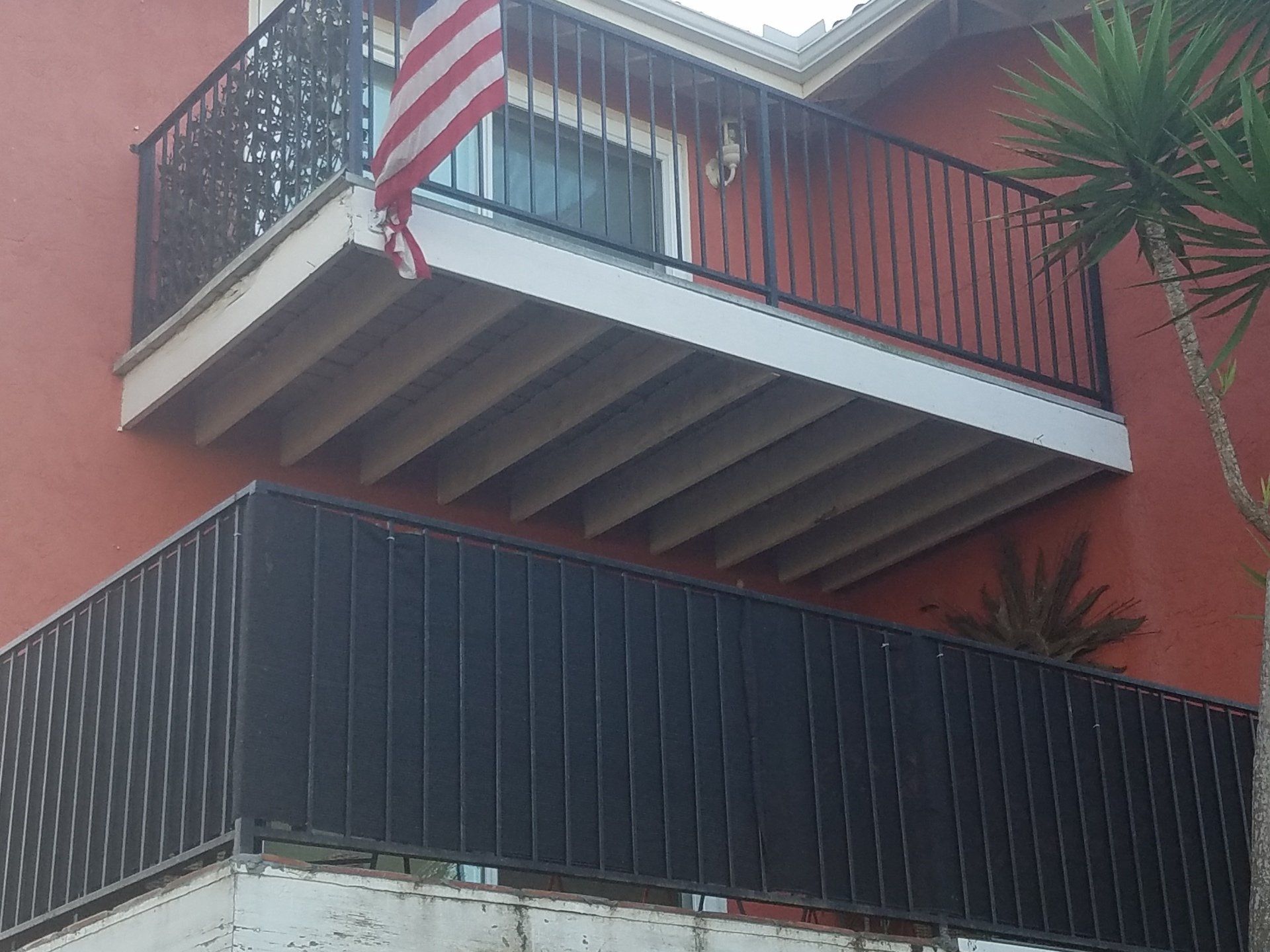 A balcony with an american flag hanging from it