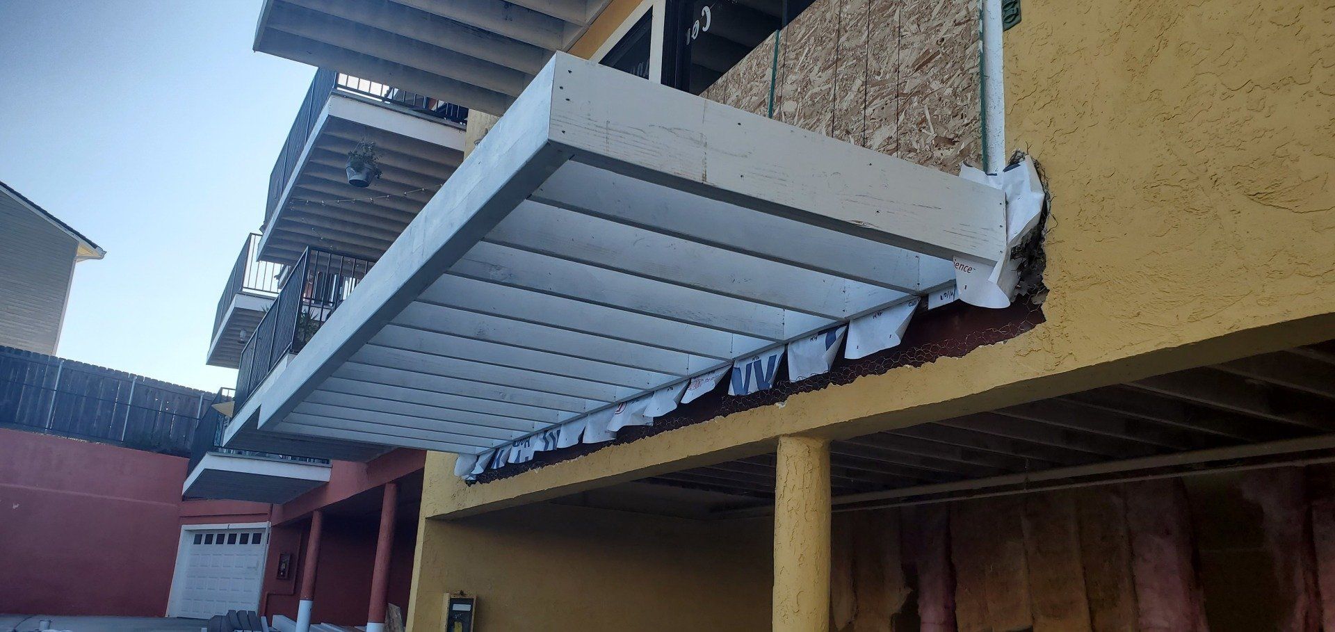 A yellow building with a white awning on the side