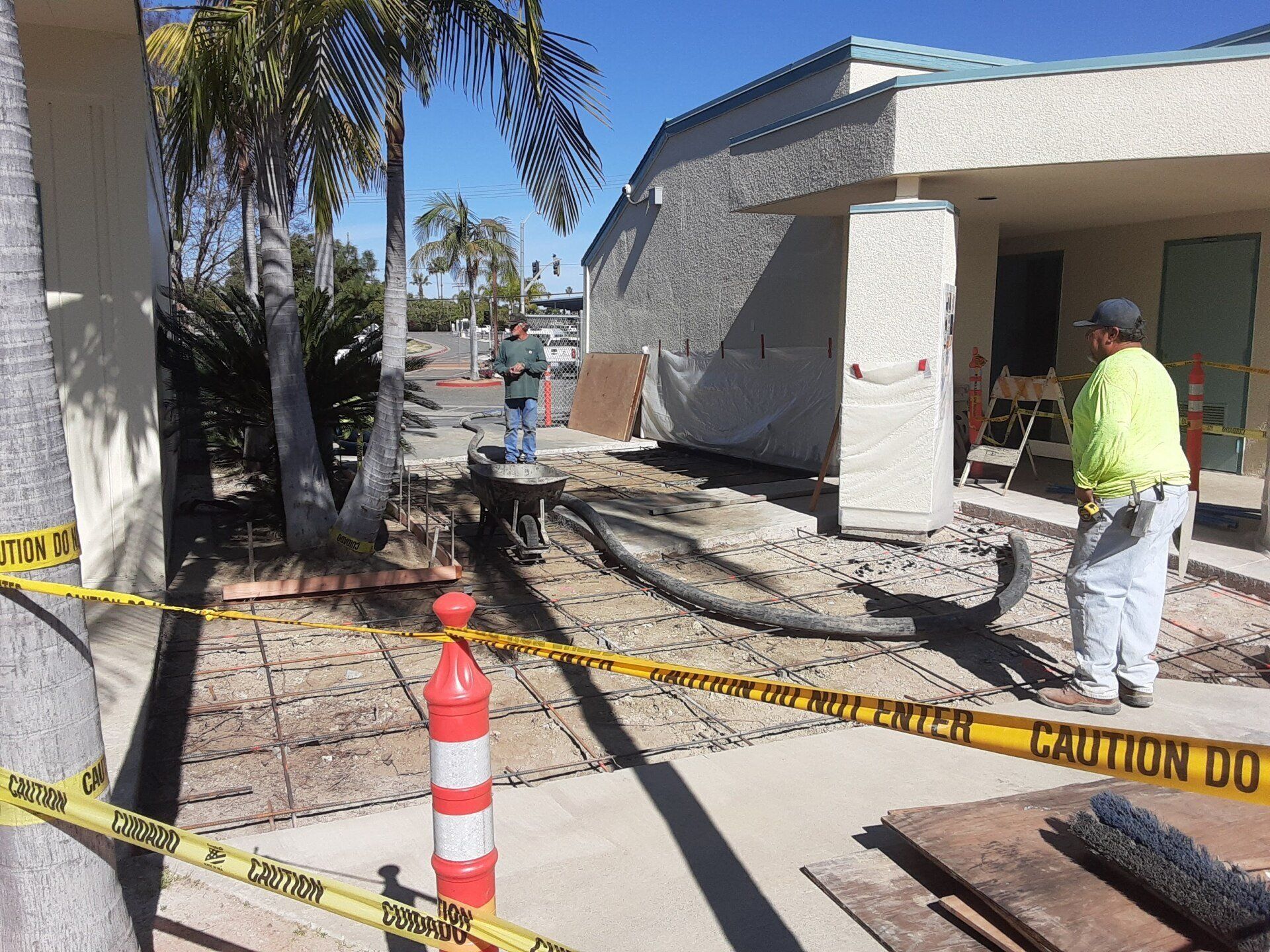 A construction site with a yellow tape that says caution do not enter