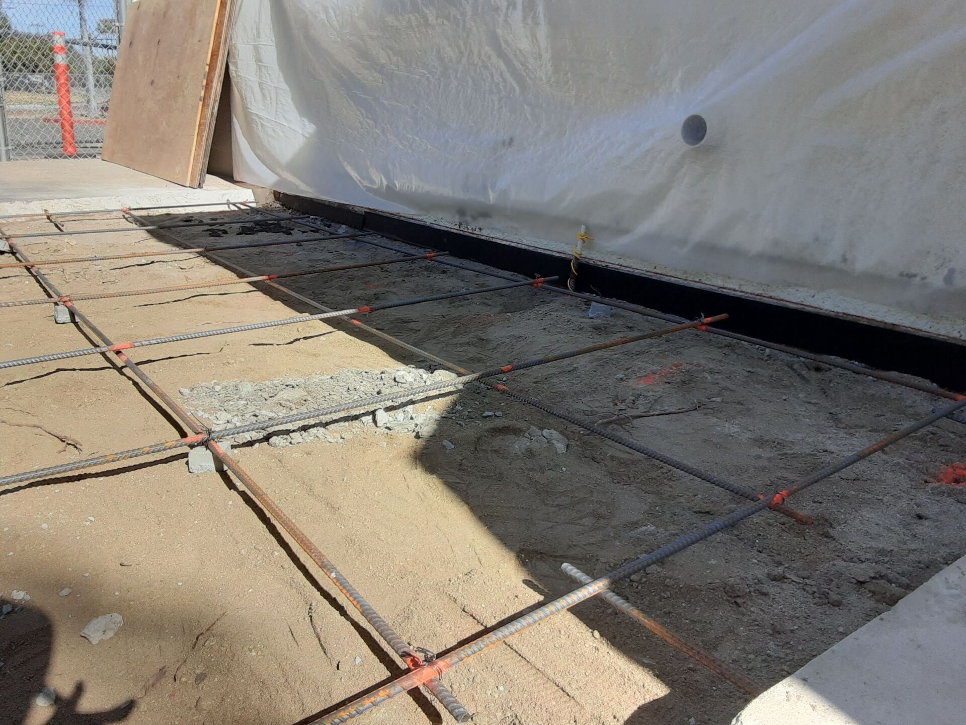 A concrete floor is being built on a construction site.