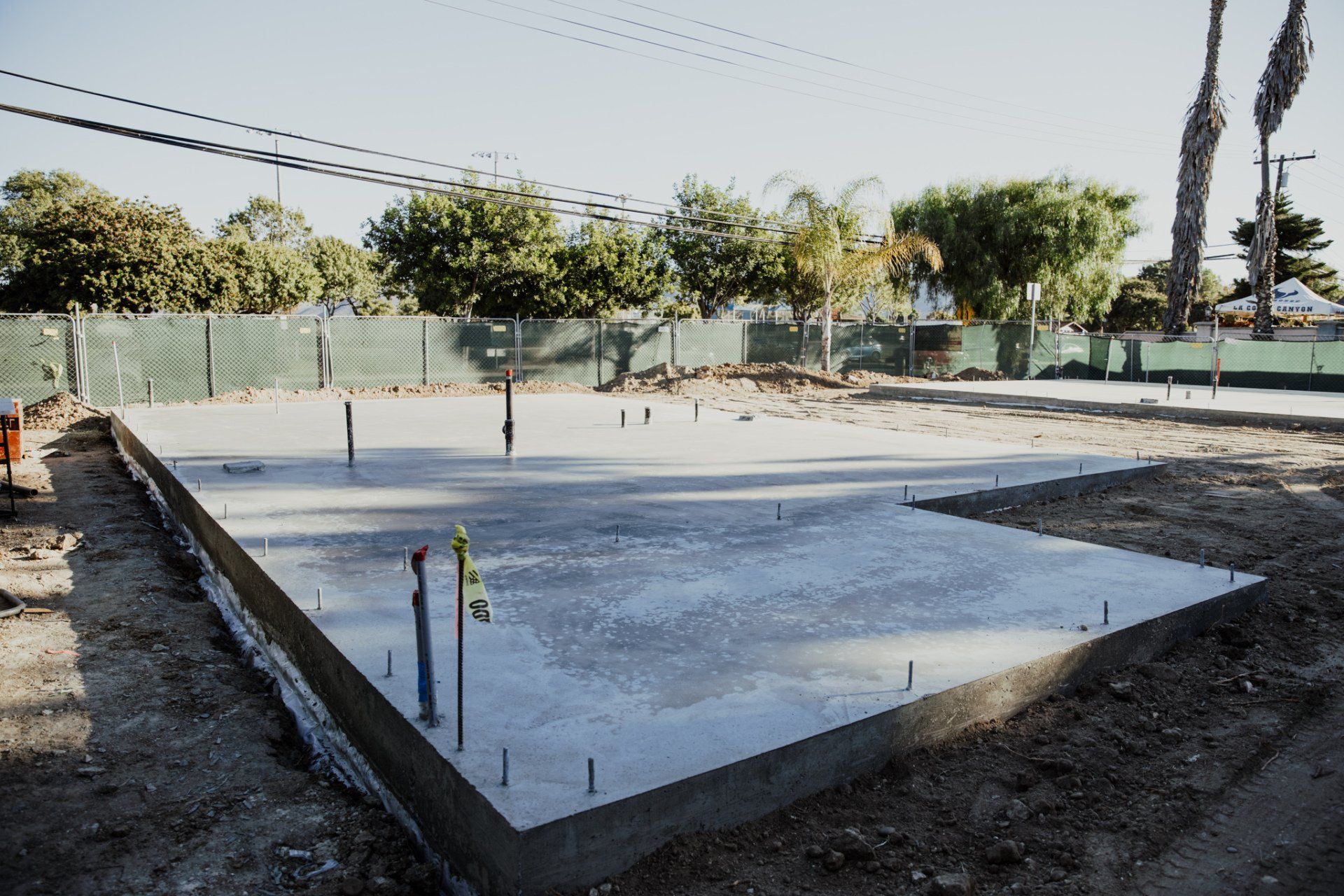 A large concrete slab is sitting in the middle of a dirt field.