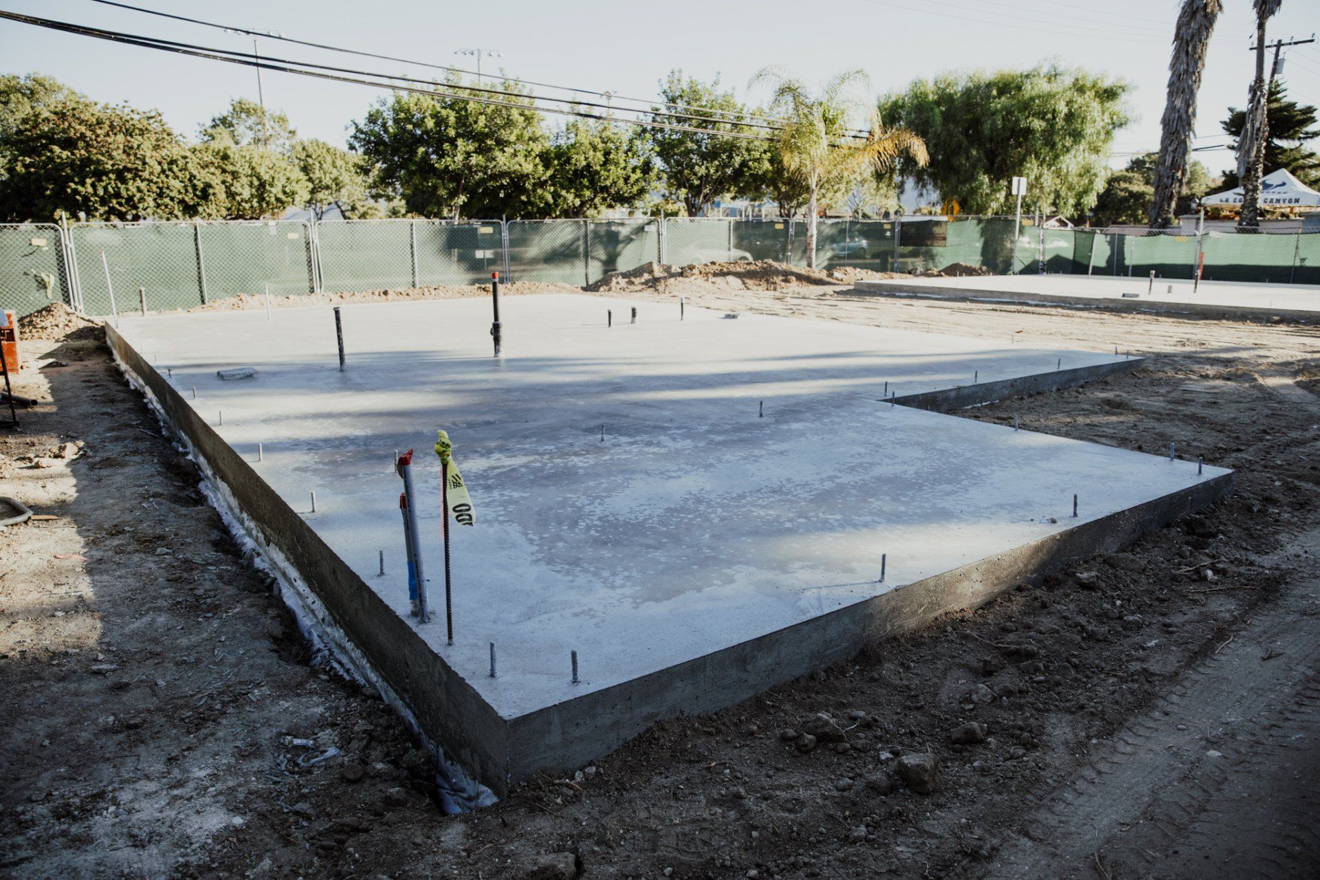 A concrete foundation is being built in a yard.