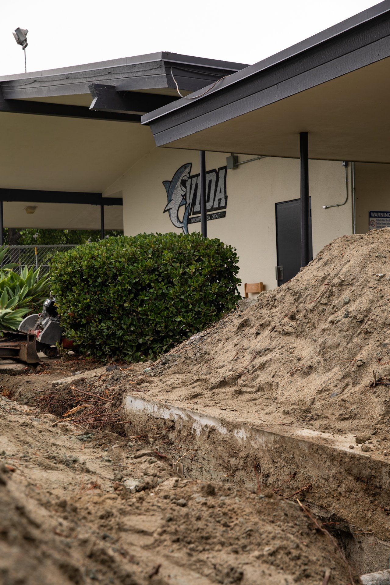 A large pile of dirt is in front of a building that says yorba
