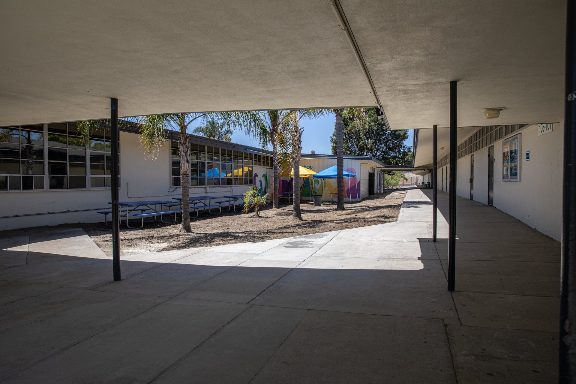 A covered walkway leading to a school building