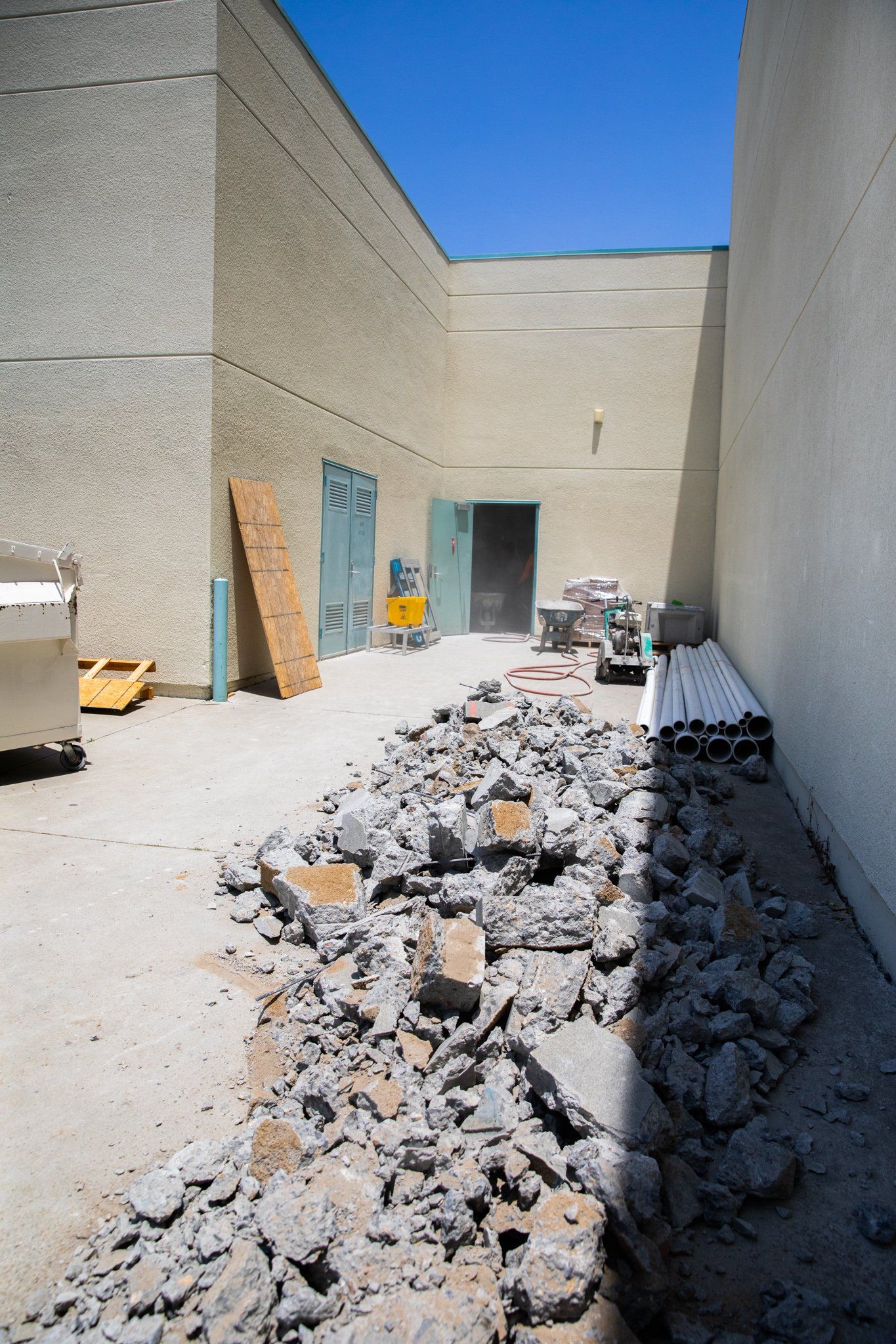 A pile of rocks is sitting in front of a building.