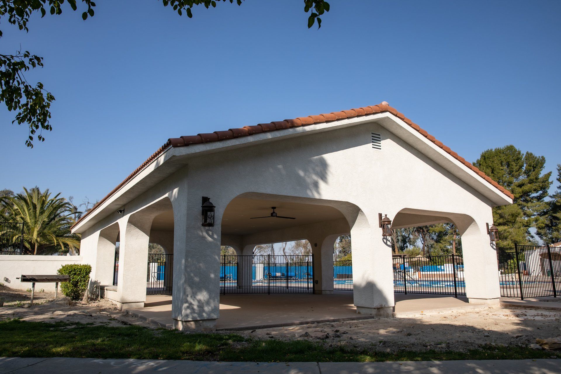 A large white building with a red tile roof