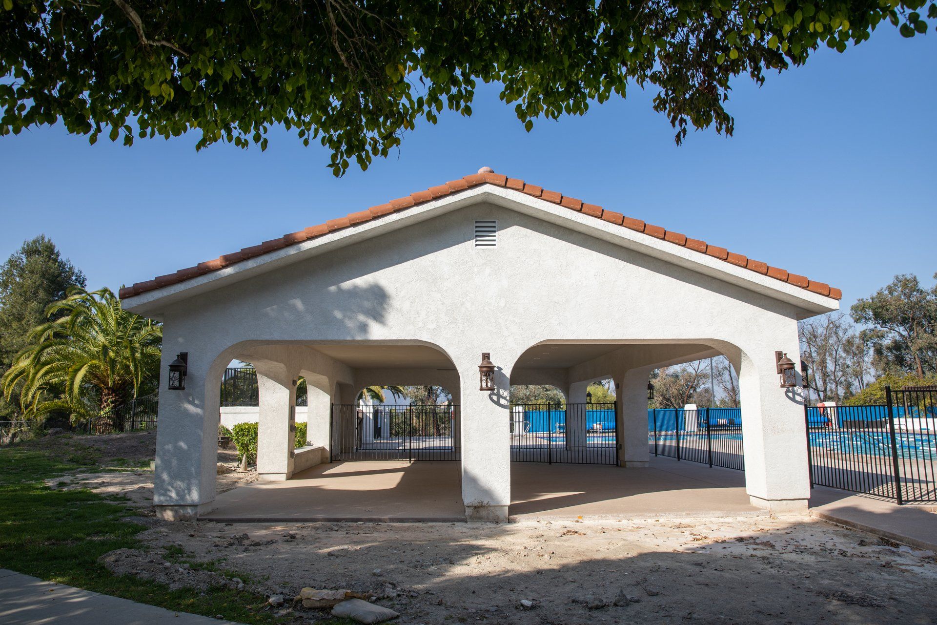 A large white building with a red tile roof