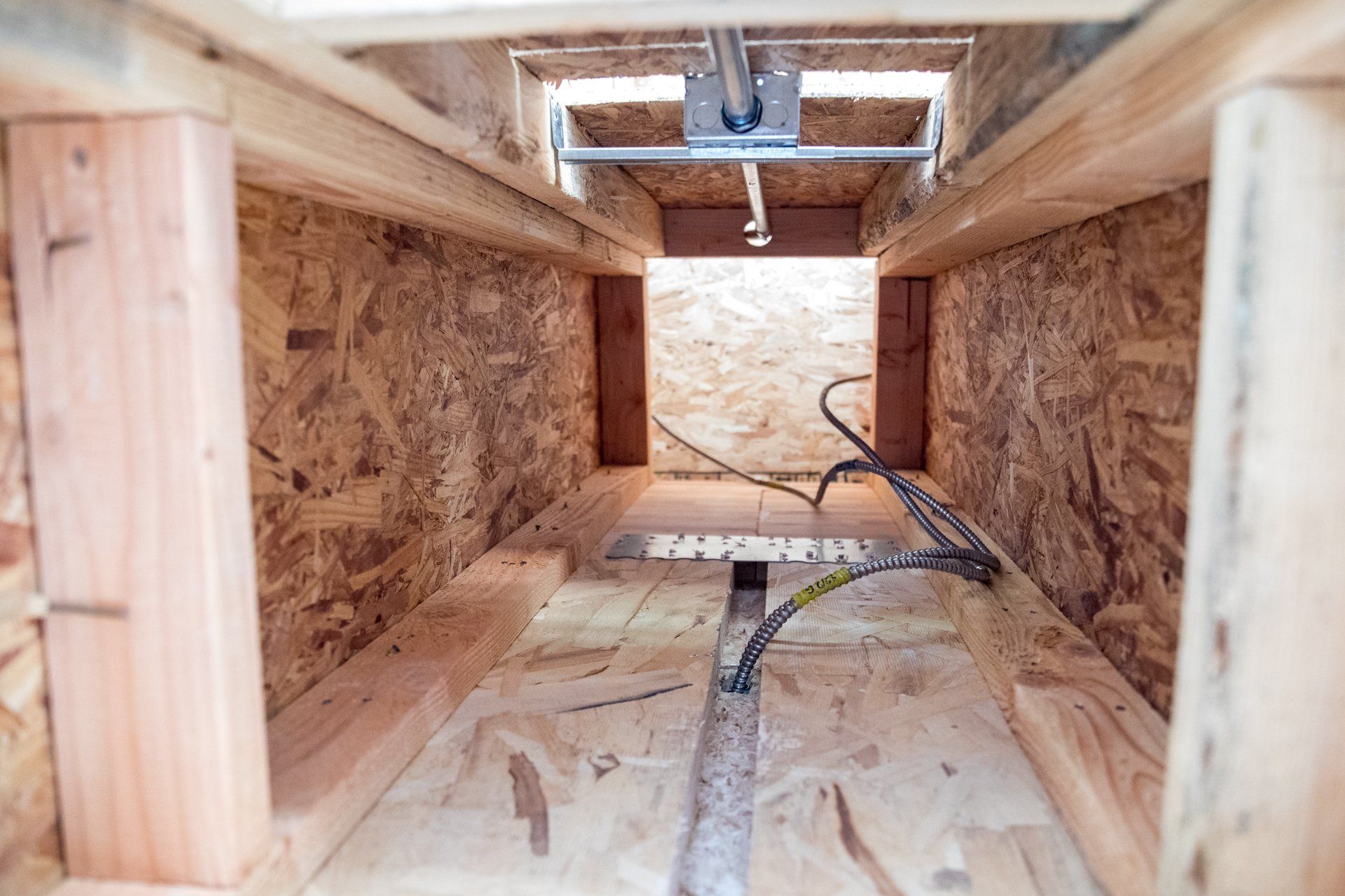 A wooden structure with a few wires coming out of it.