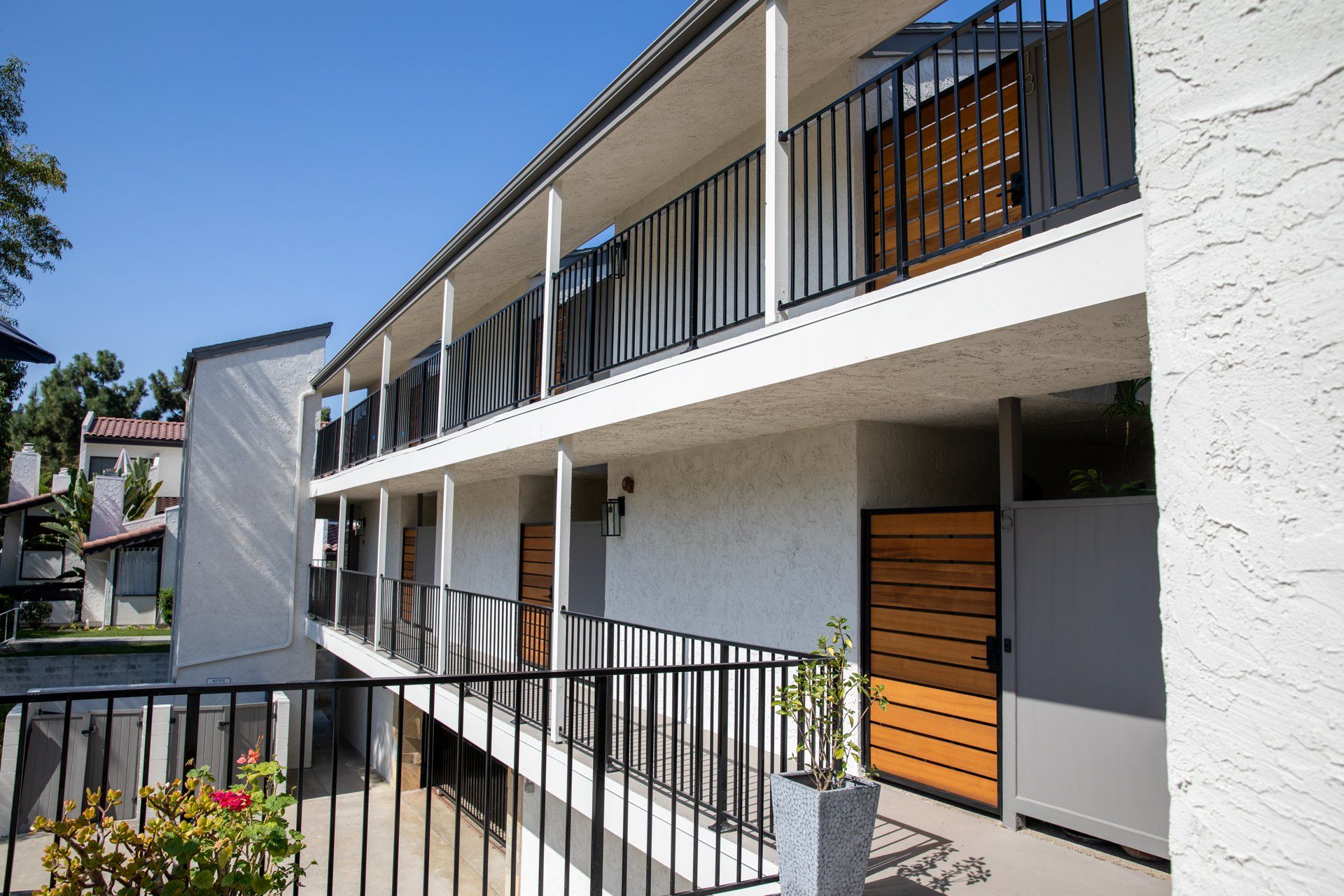 A large apartment building with a balcony and a fence