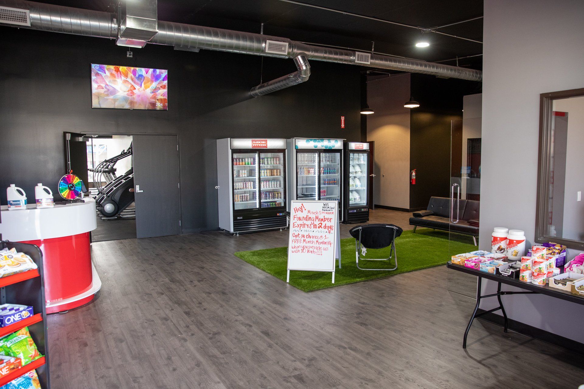 A large room with a table and refrigerators in it.