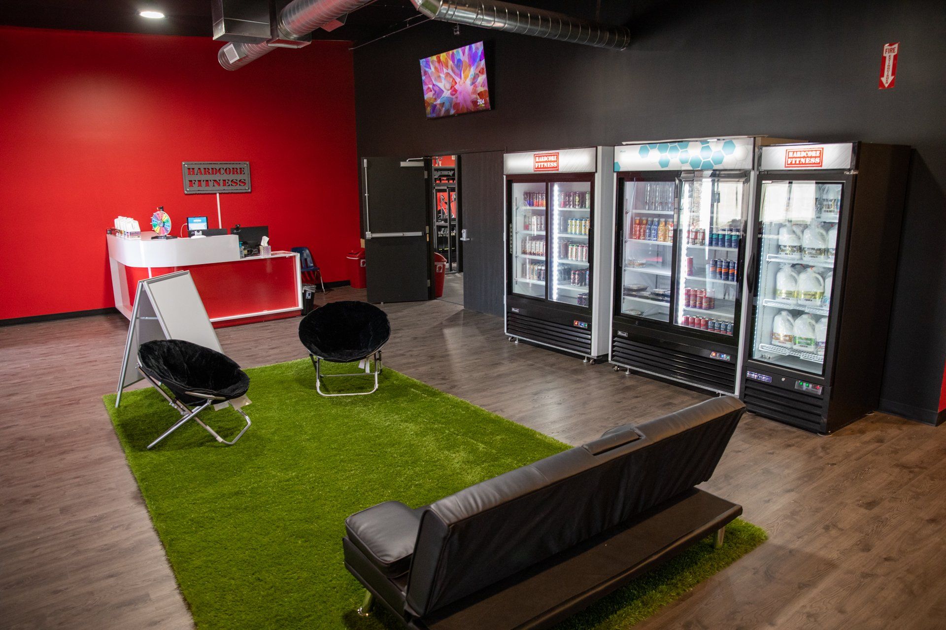 A living room with a couch , chairs and refrigerators.