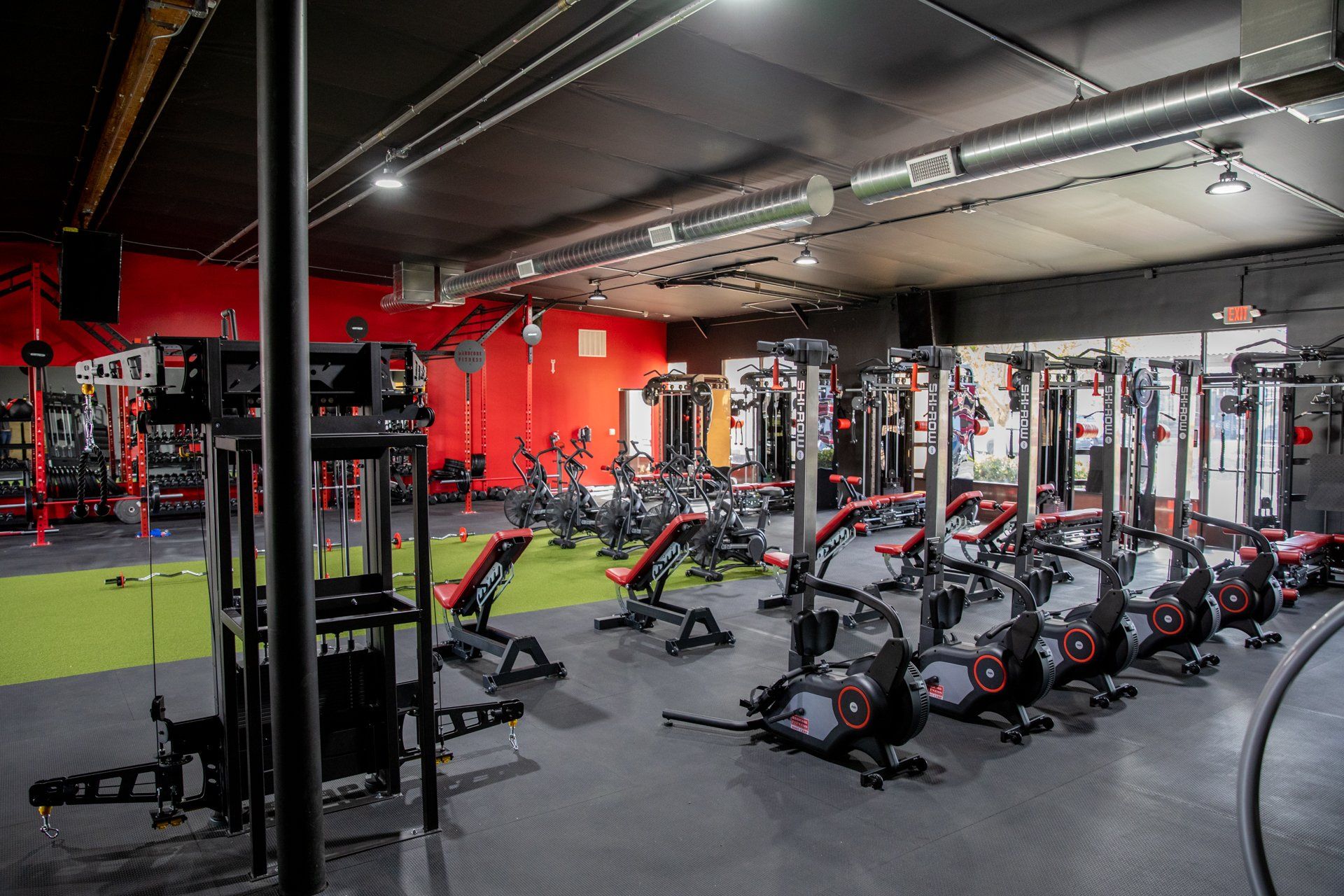 A large gym filled with lots of exercise equipment.