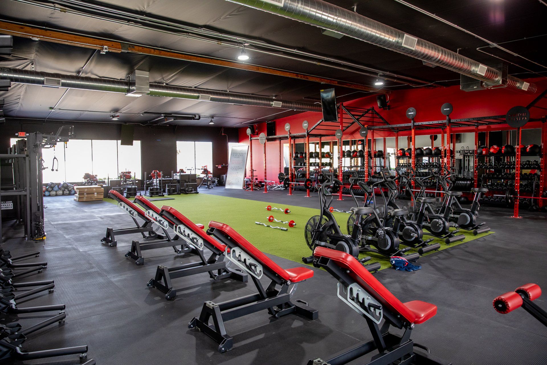 A large gym filled with lots of exercise equipment.