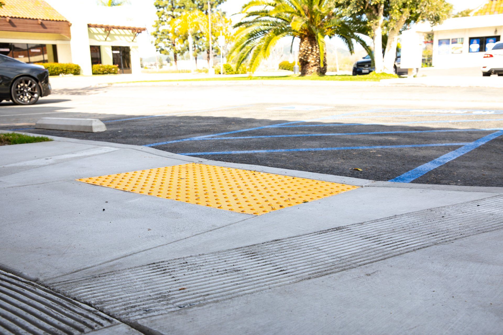 A black car is parked in a handicapped parking spot