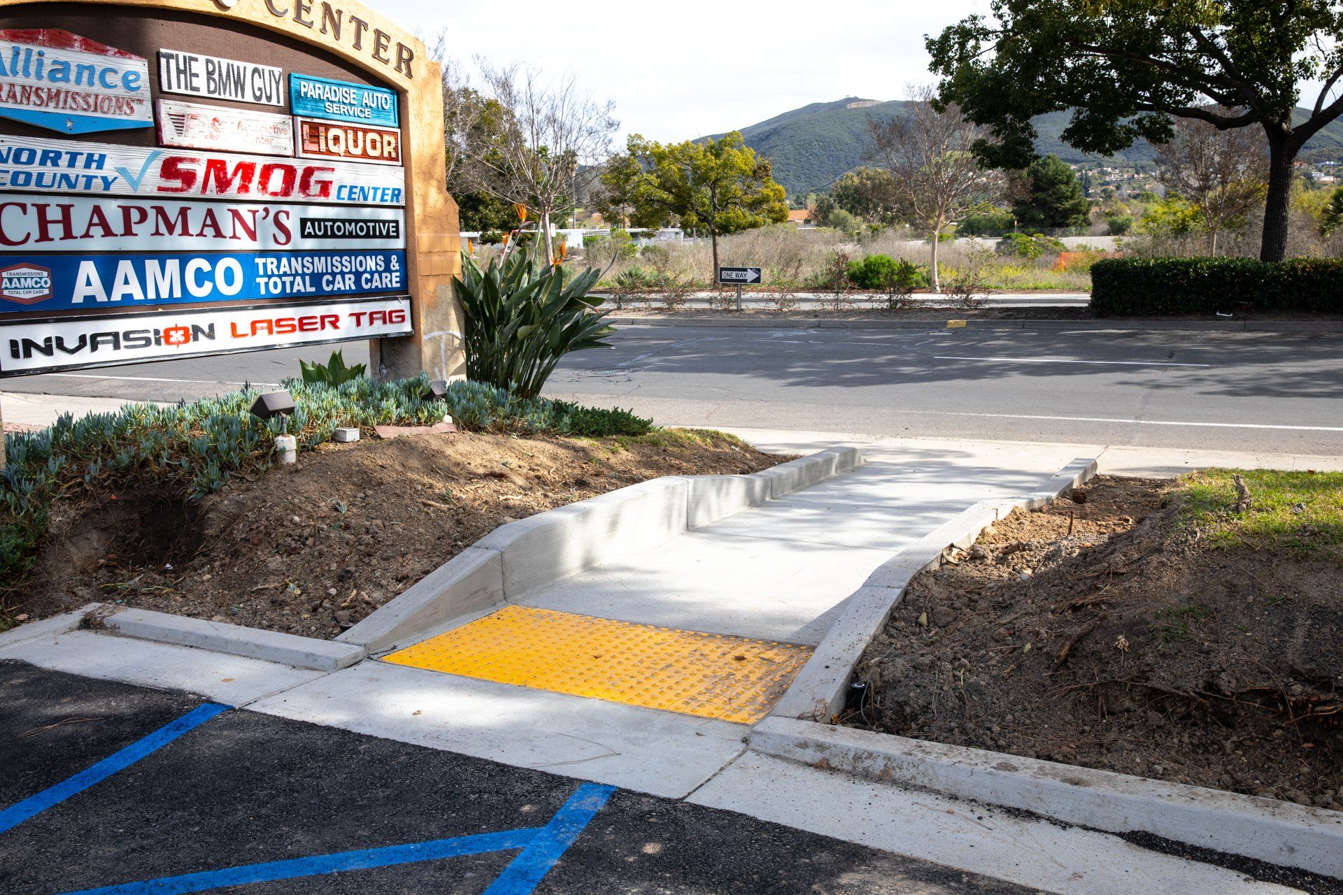 A parking lot with a ramp and a sign that says alliance