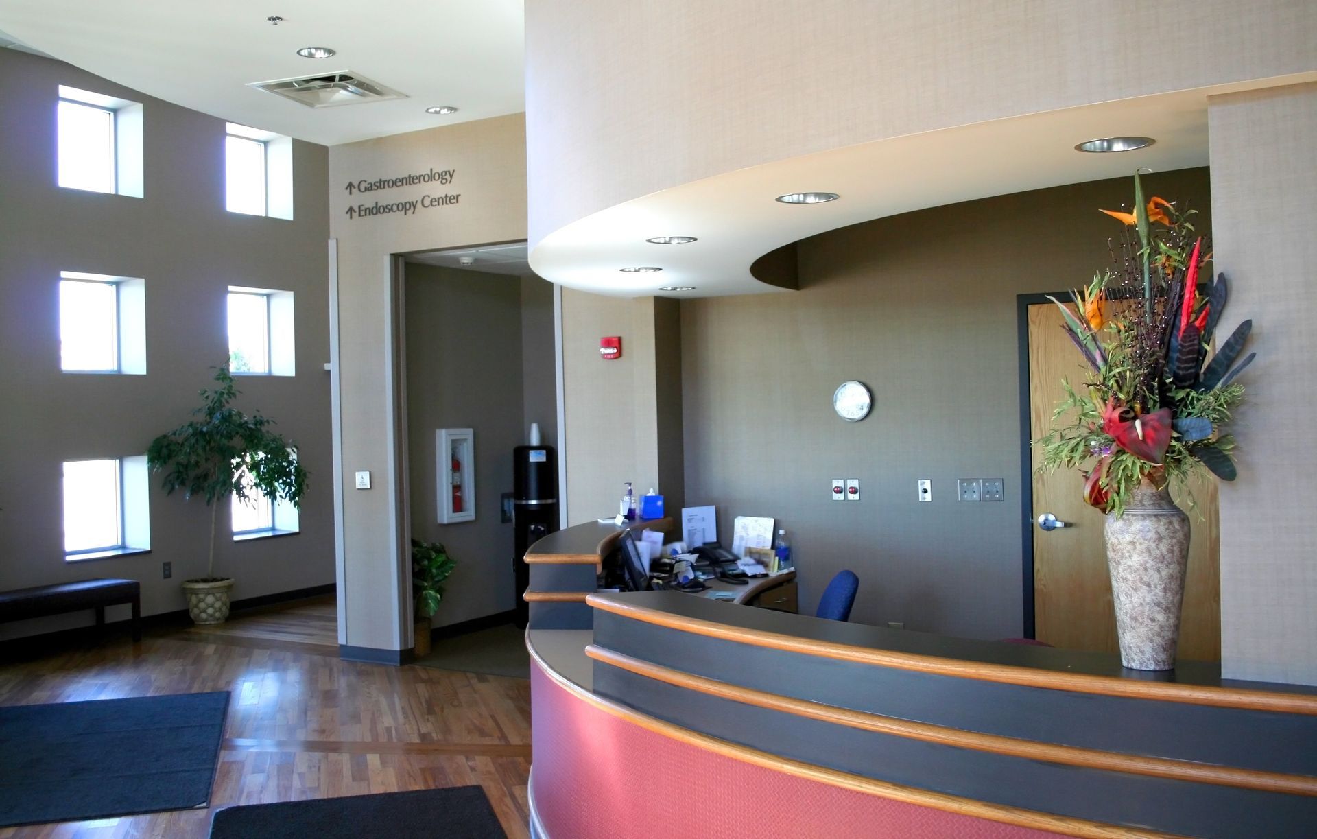 A reception desk with a vase of flowers on it