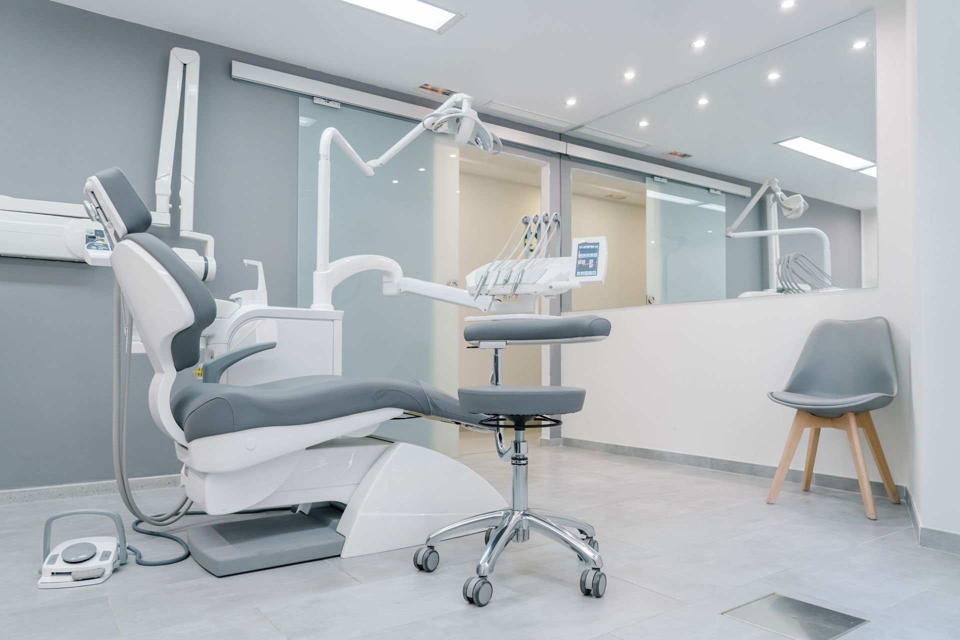 A dental office with a dental chair and chairs.