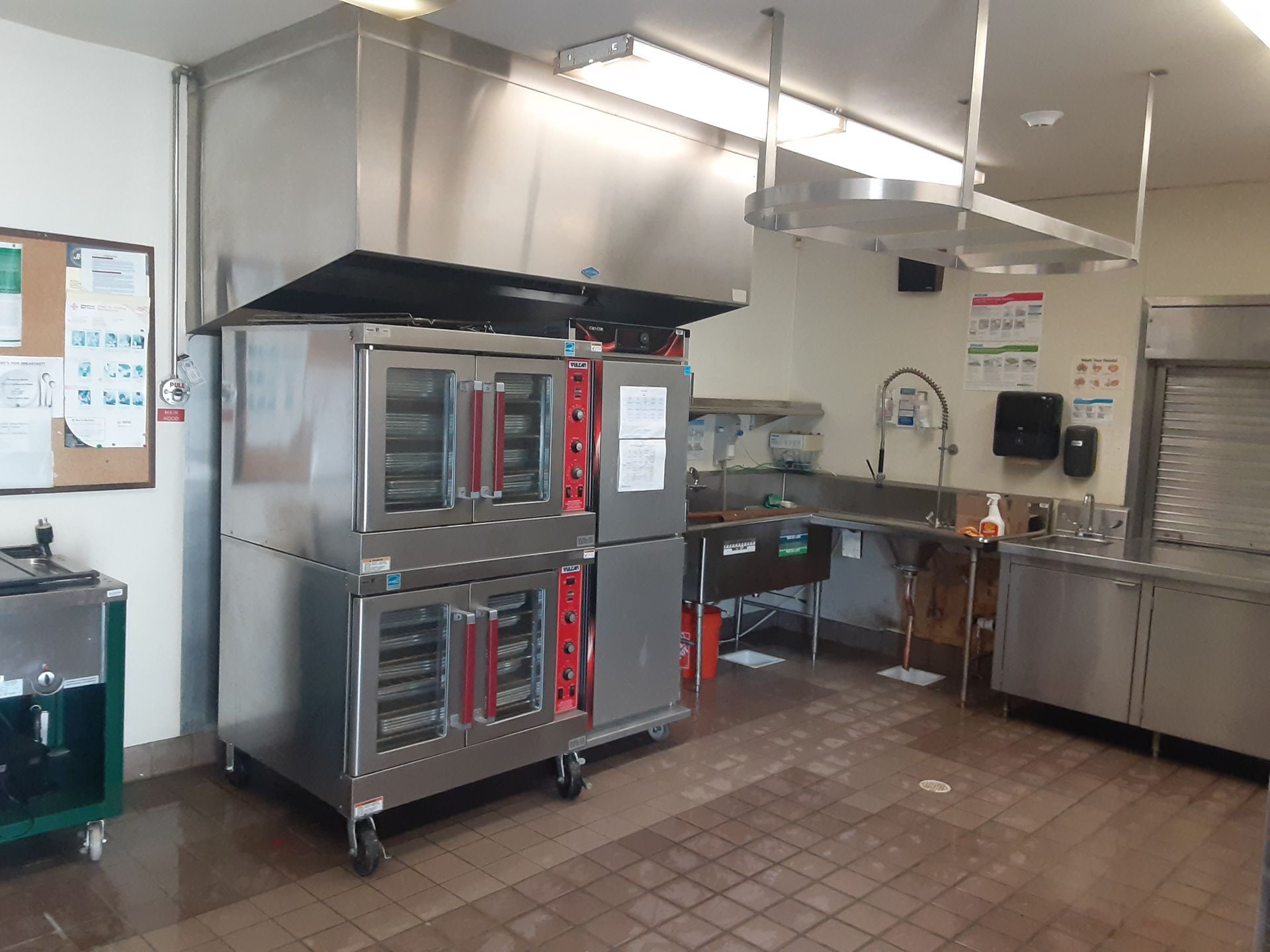 A kitchen with stainless steel appliances and a large oven.