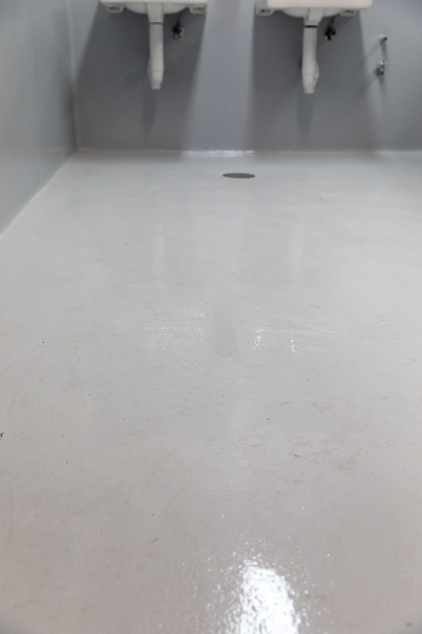 A bathroom with two sinks and a white floor.