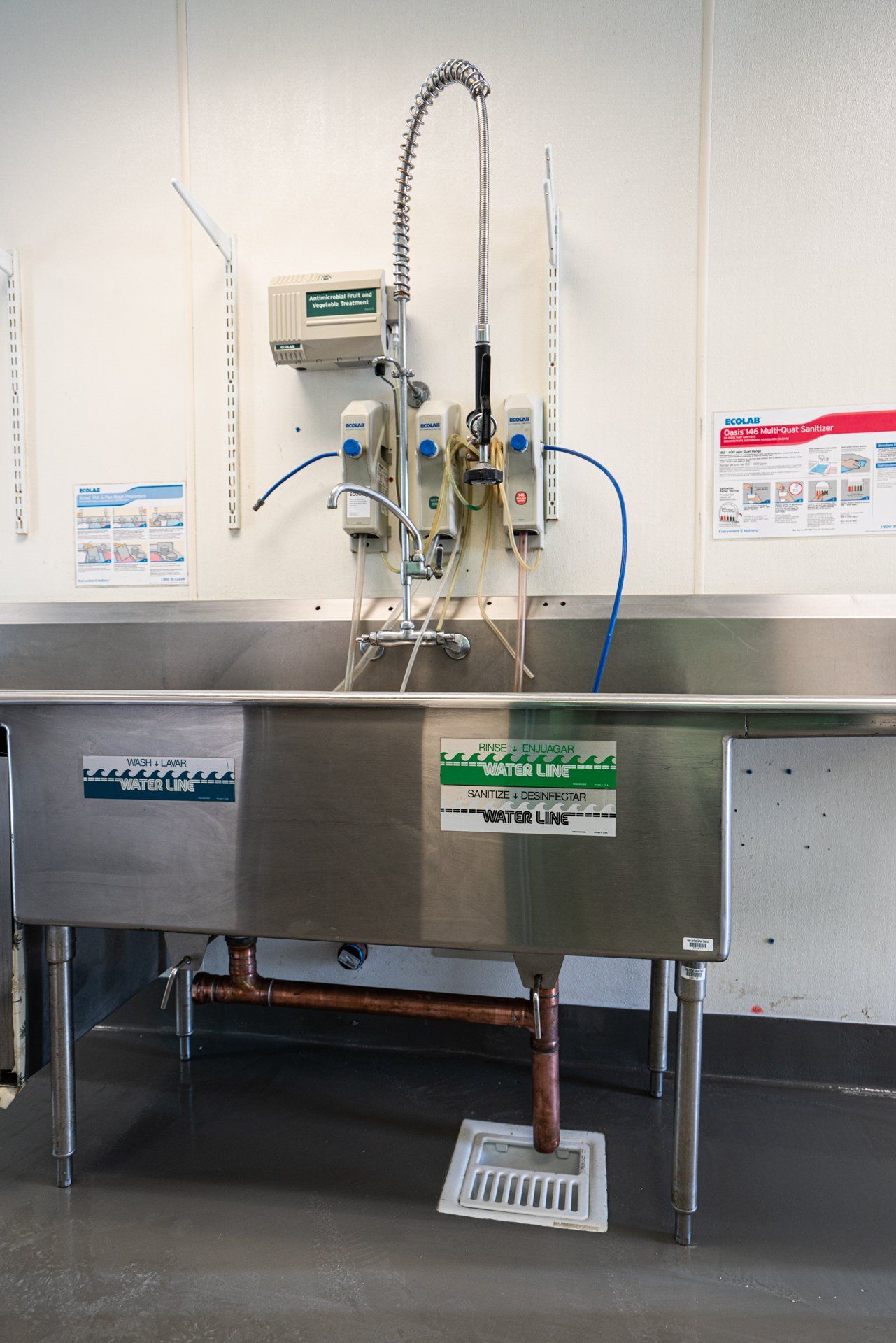 A stainless steel sink with a green sticker on it