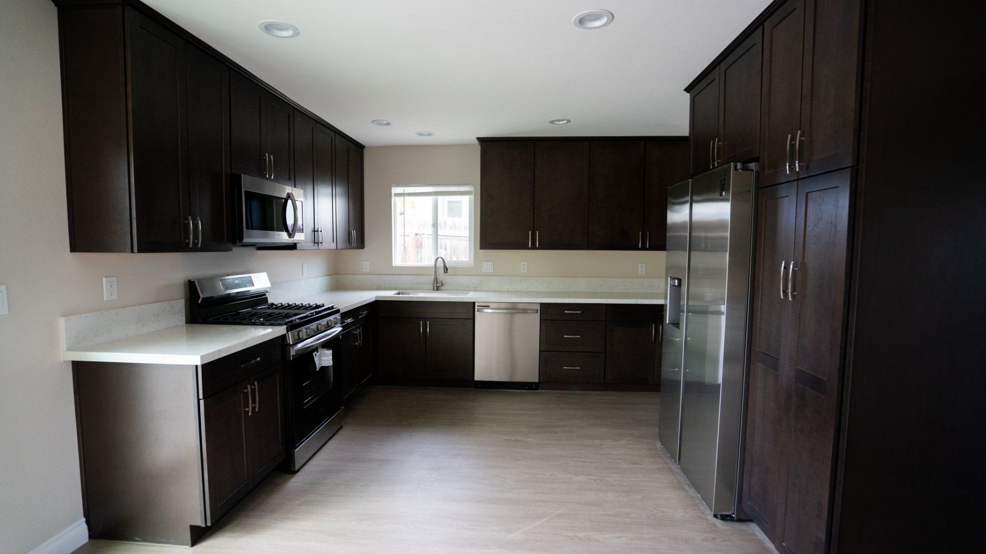 A kitchen with brown cabinets and stainless steel appliances