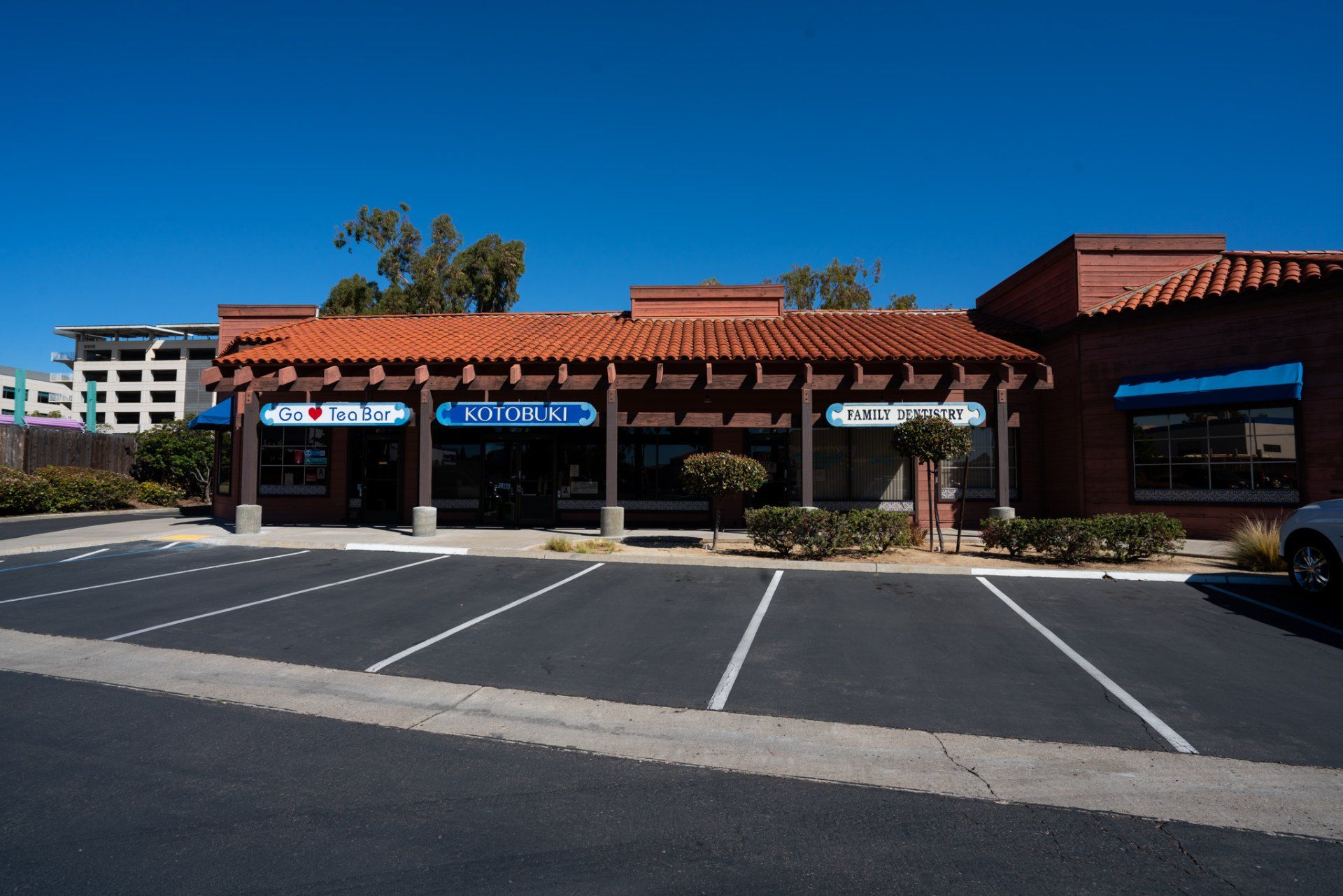 A car is parked in front of a building that says domino 's