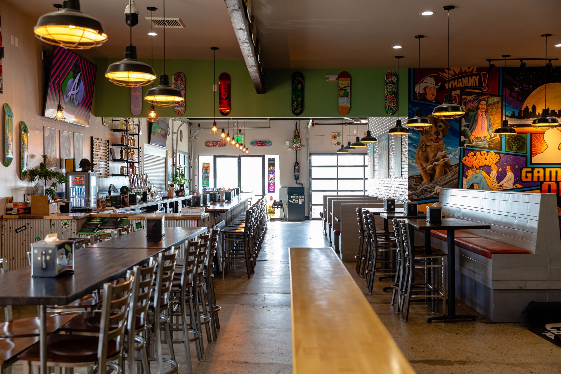 A restaurant with a mural on the wall that says game on it