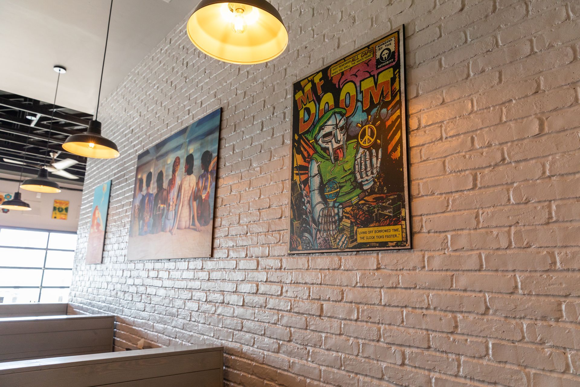 A brick wall with a painting on it in a restaurant