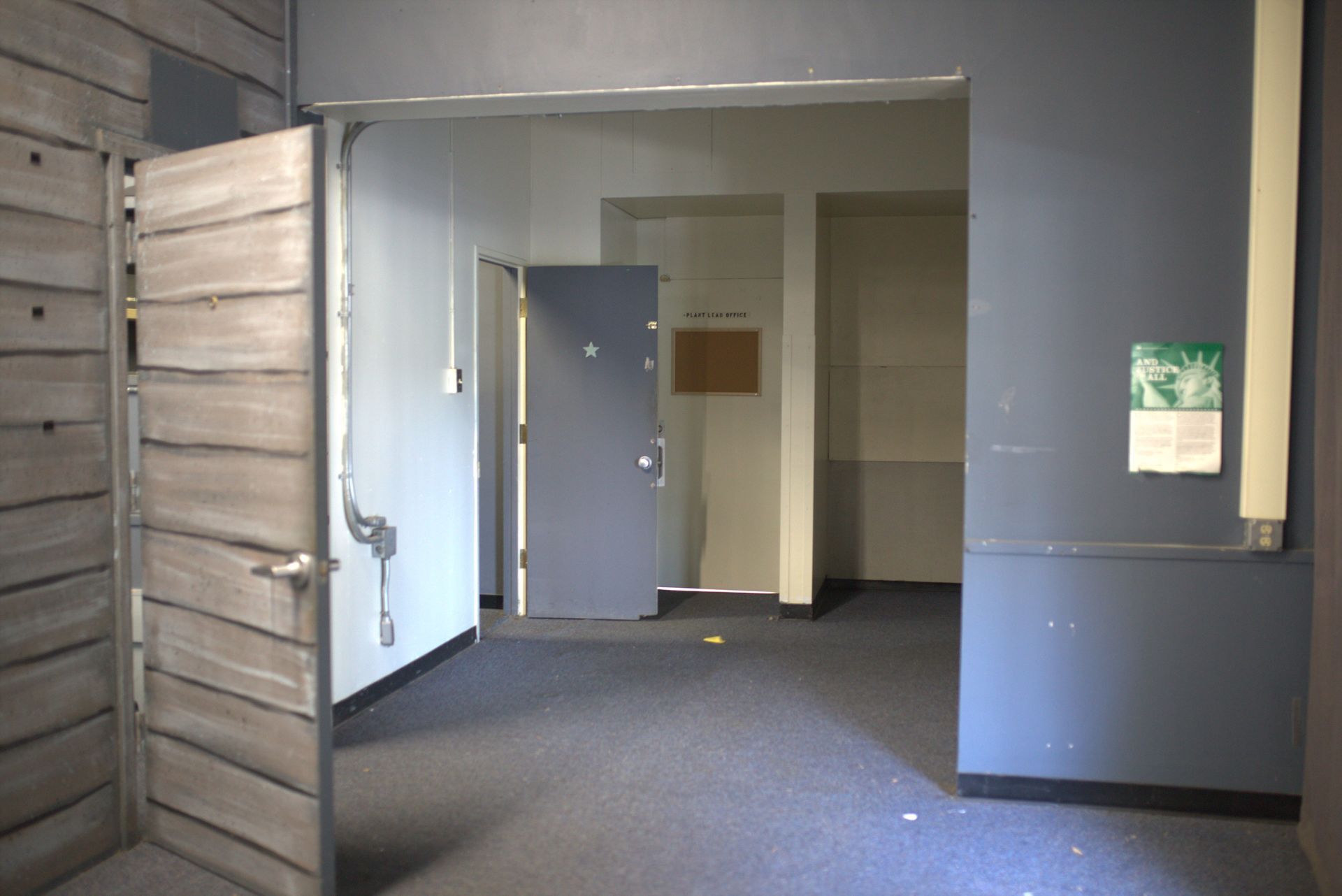 An empty room with a green sign on the wall