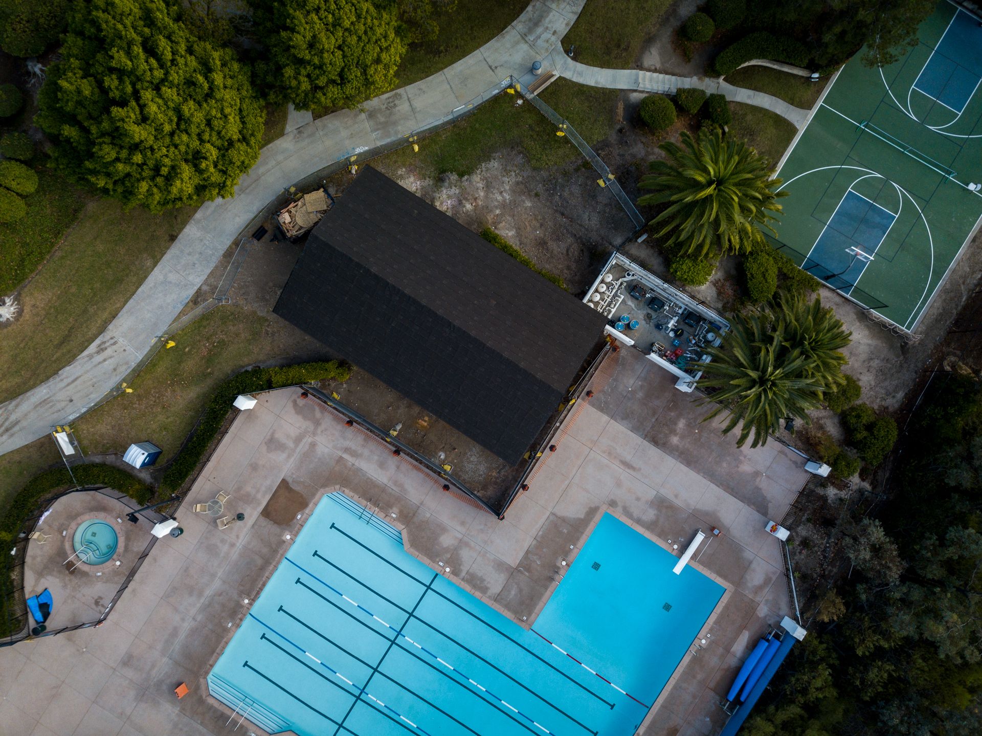 An aerial view of a swimming pool in a park