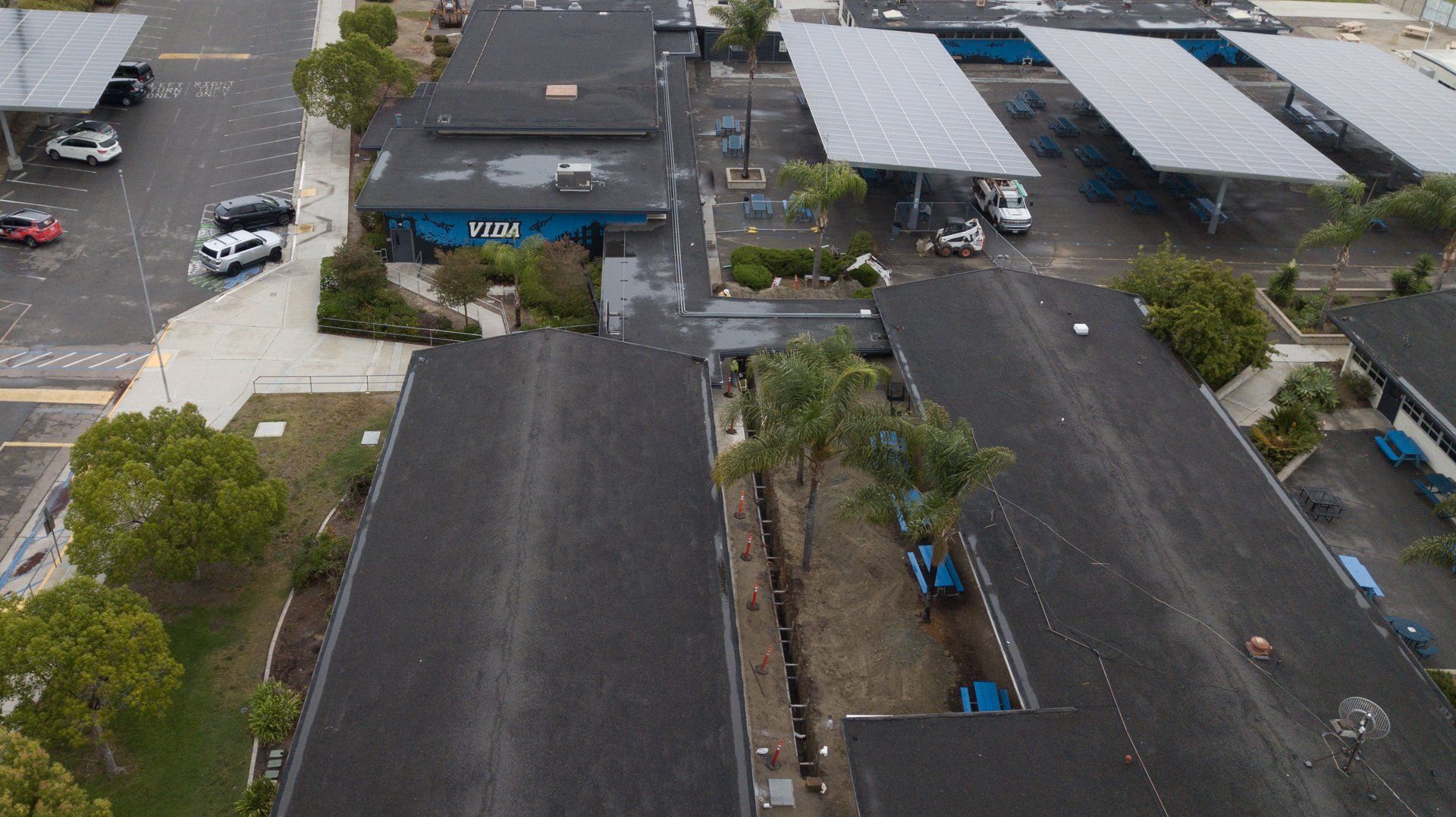 An aerial view of a parking lot with a building that says an on it