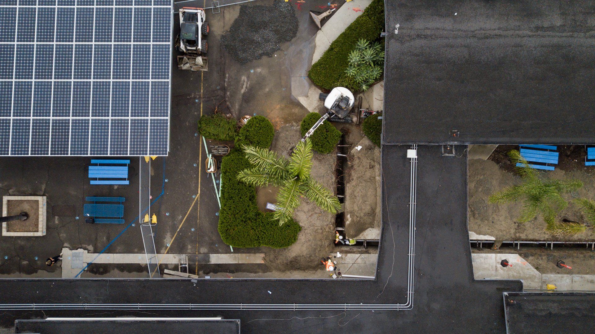 An aerial view of a building with solar panels on the roof