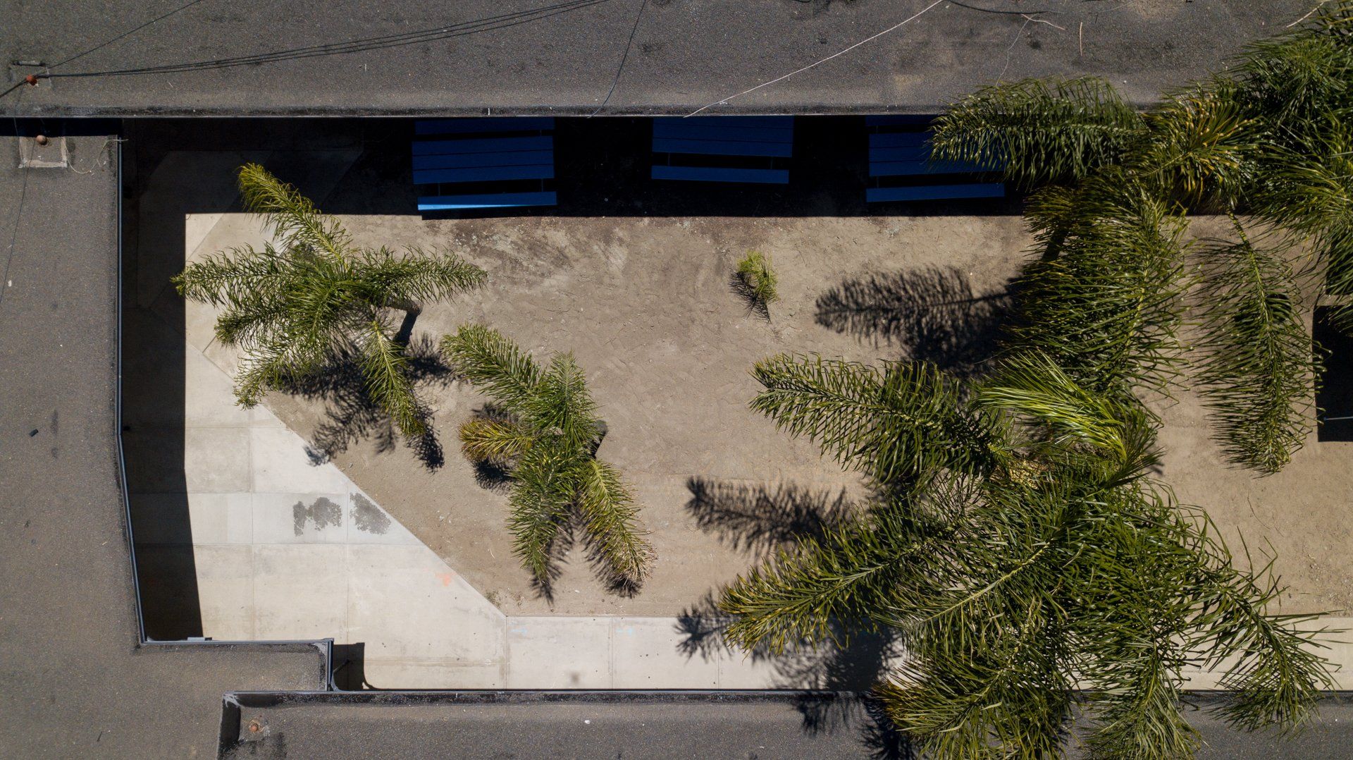 An aerial view of a building with trees in front of it