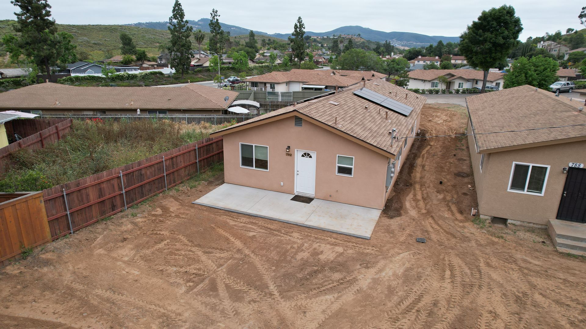 An aerial view of a house with solar panels on the roof