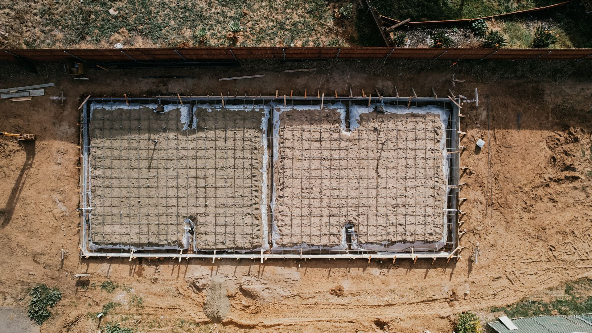 An aerial view of a concrete foundation under construction