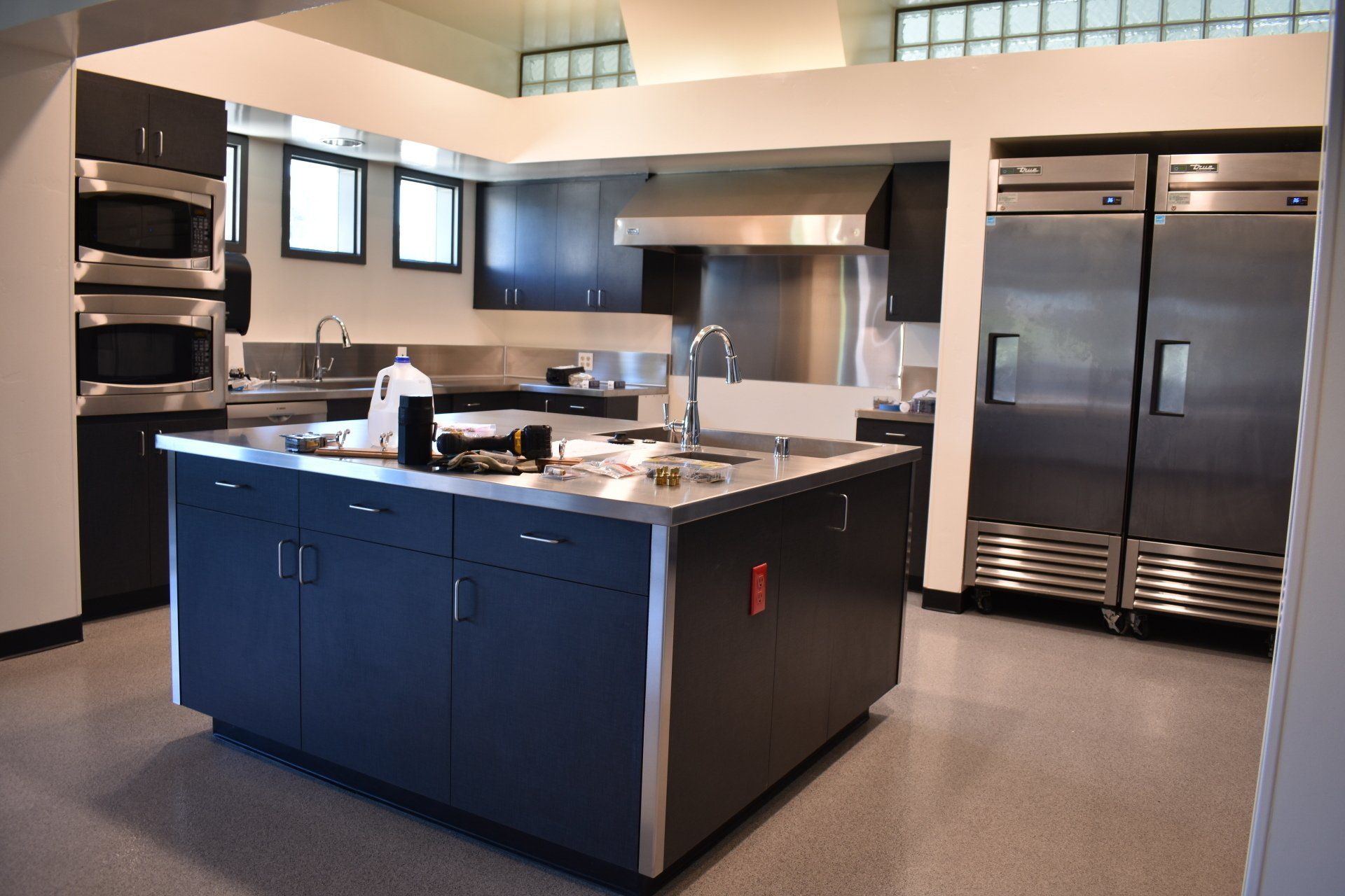A kitchen with stainless steel appliances and a large island