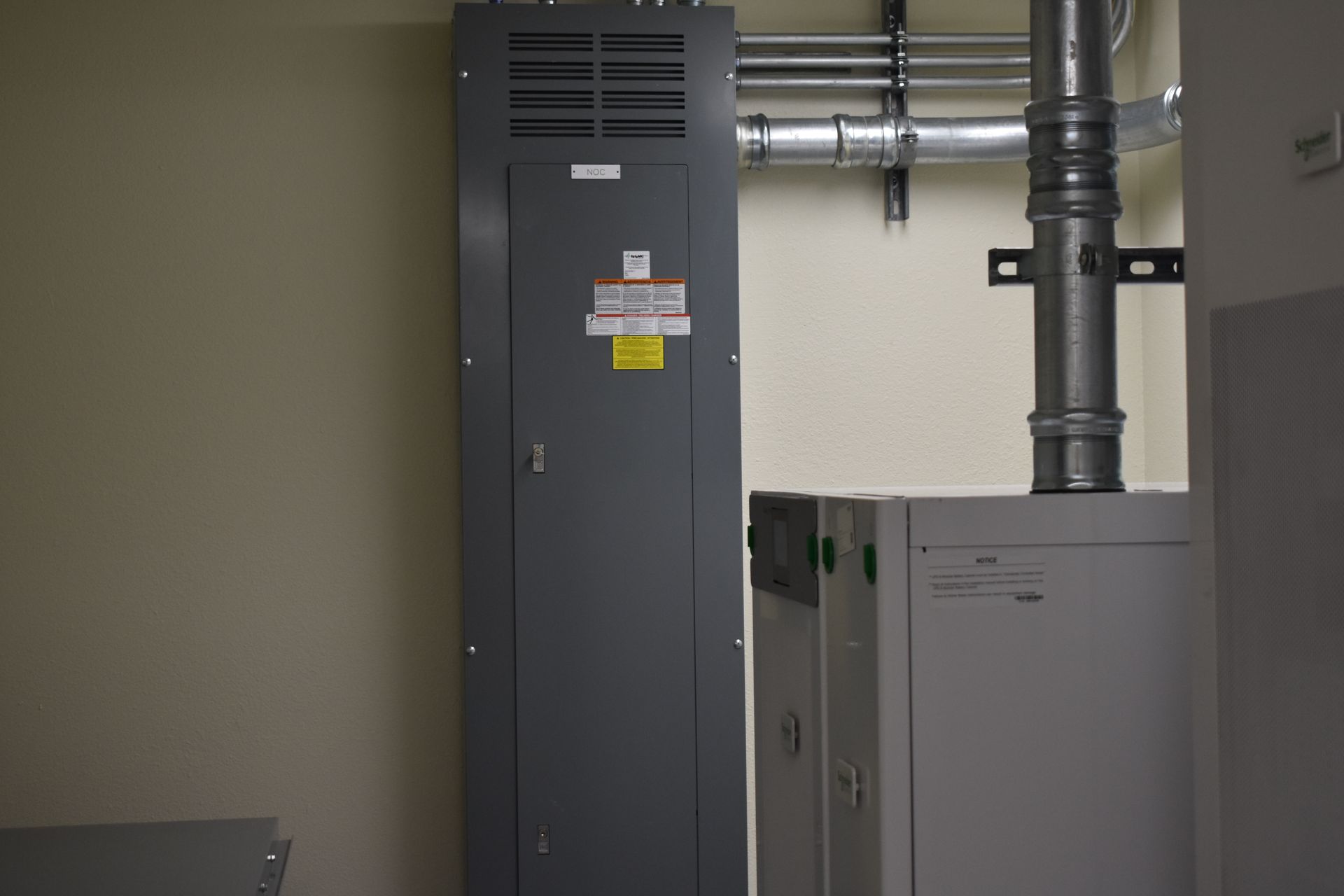 A room with a boiler and a electrical box