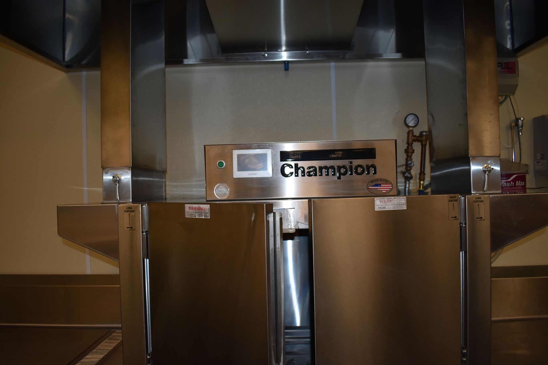 A stainless steel champion refrigerator in a kitchen