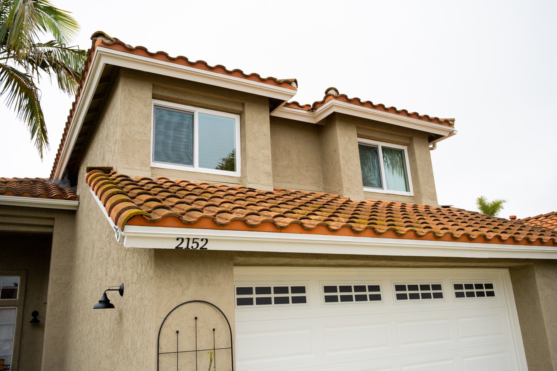 A house with a tiled roof and a white garage door