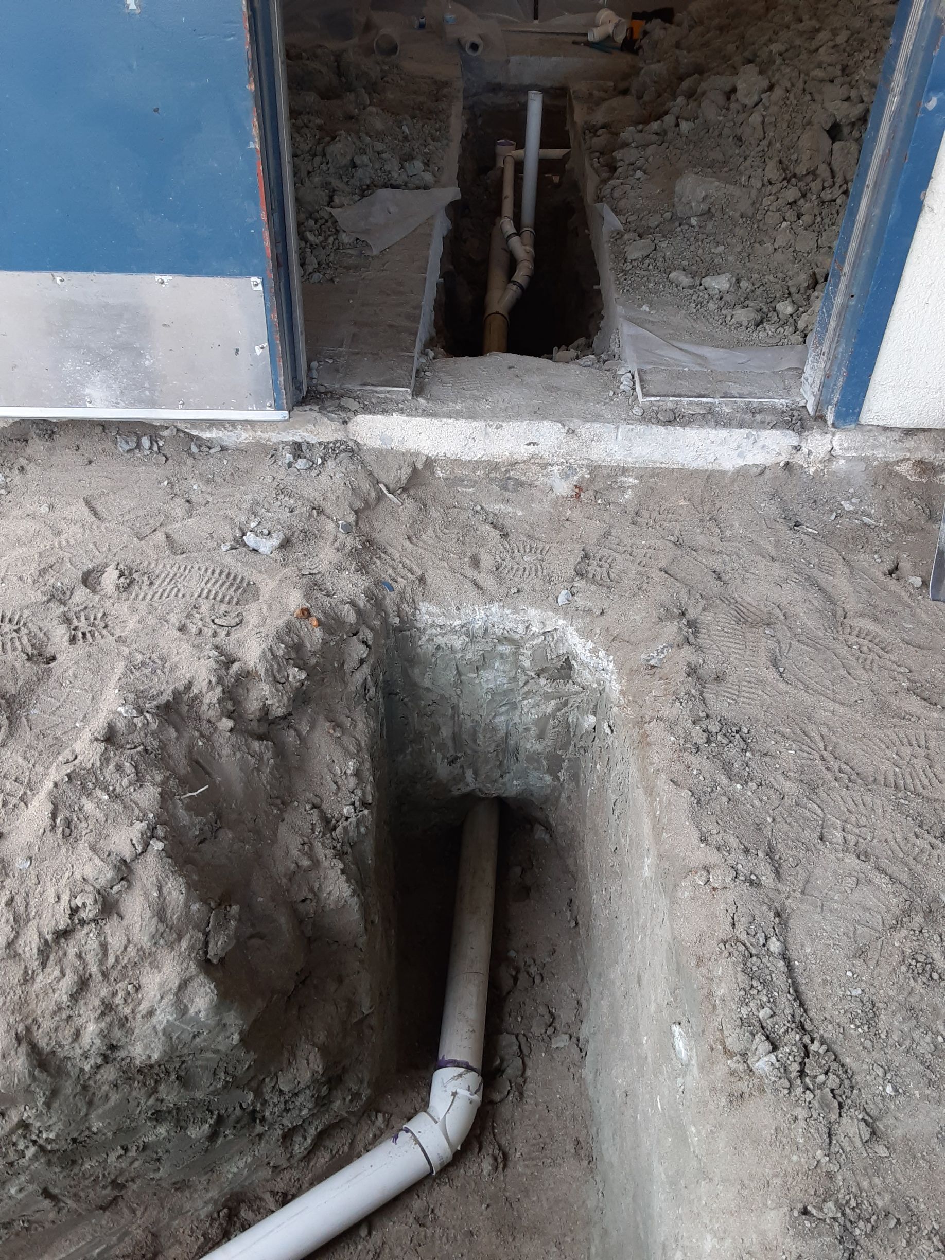 A pipe is coming out of a hole in the ground.