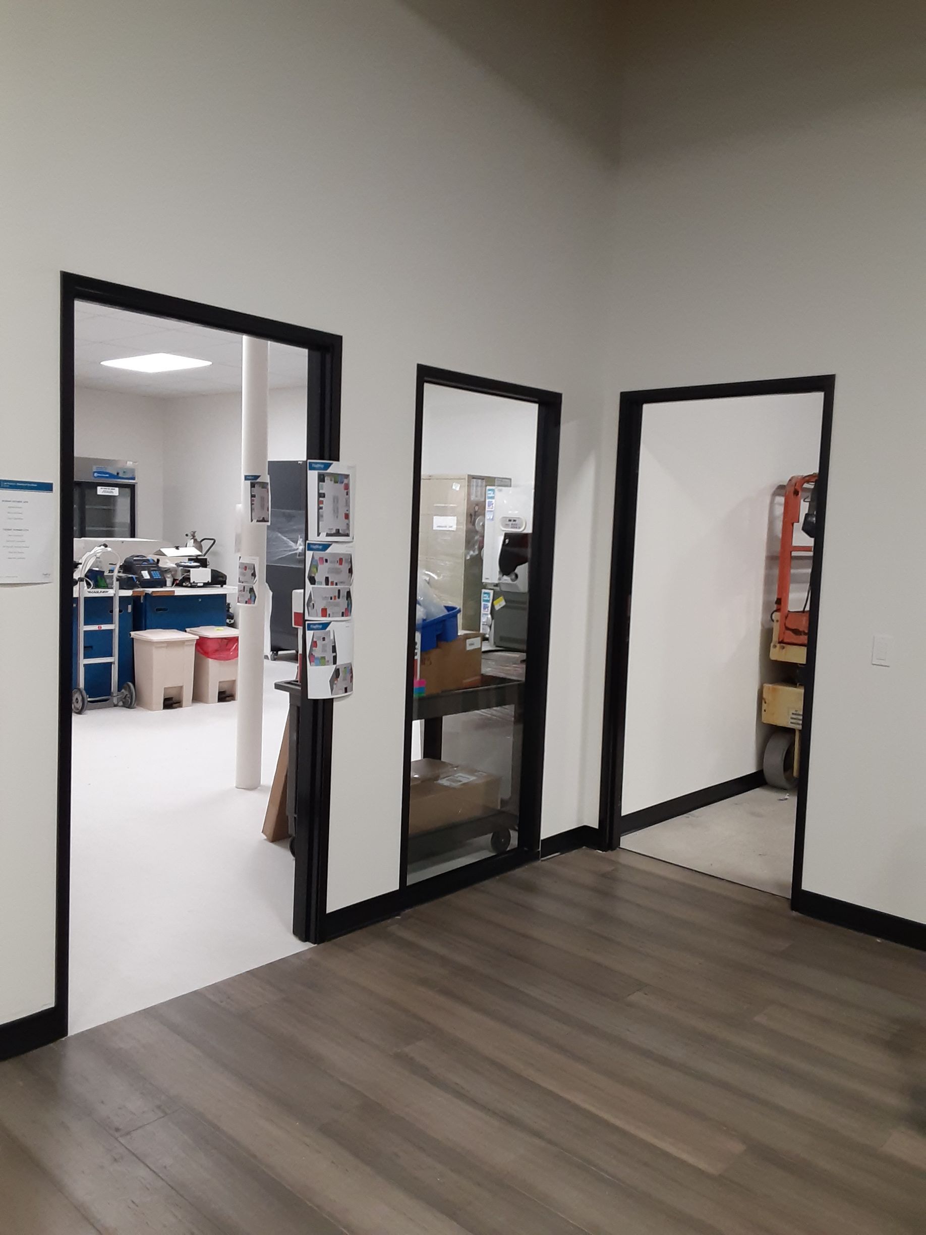 A room with a lot of doors and a wooden floor