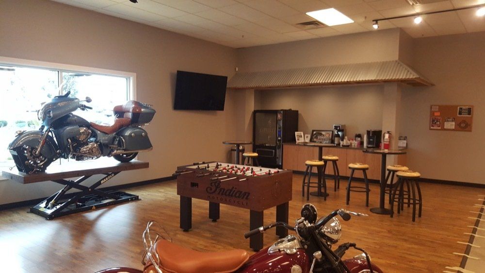 A motorcycle is sitting on top of a table in a room.