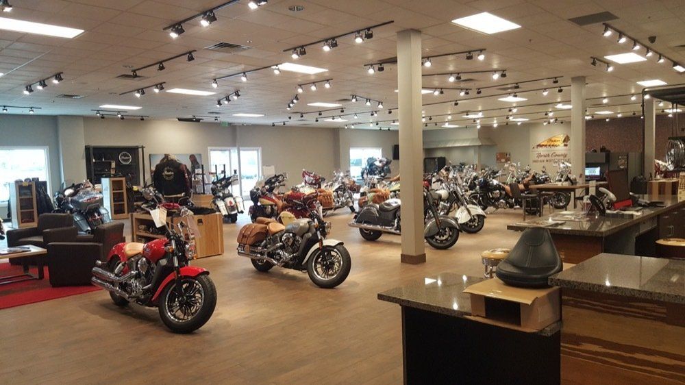 A large room filled with motorcycles and a counter.