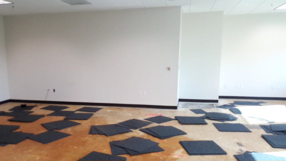 A room with a lot of black squares on the floor