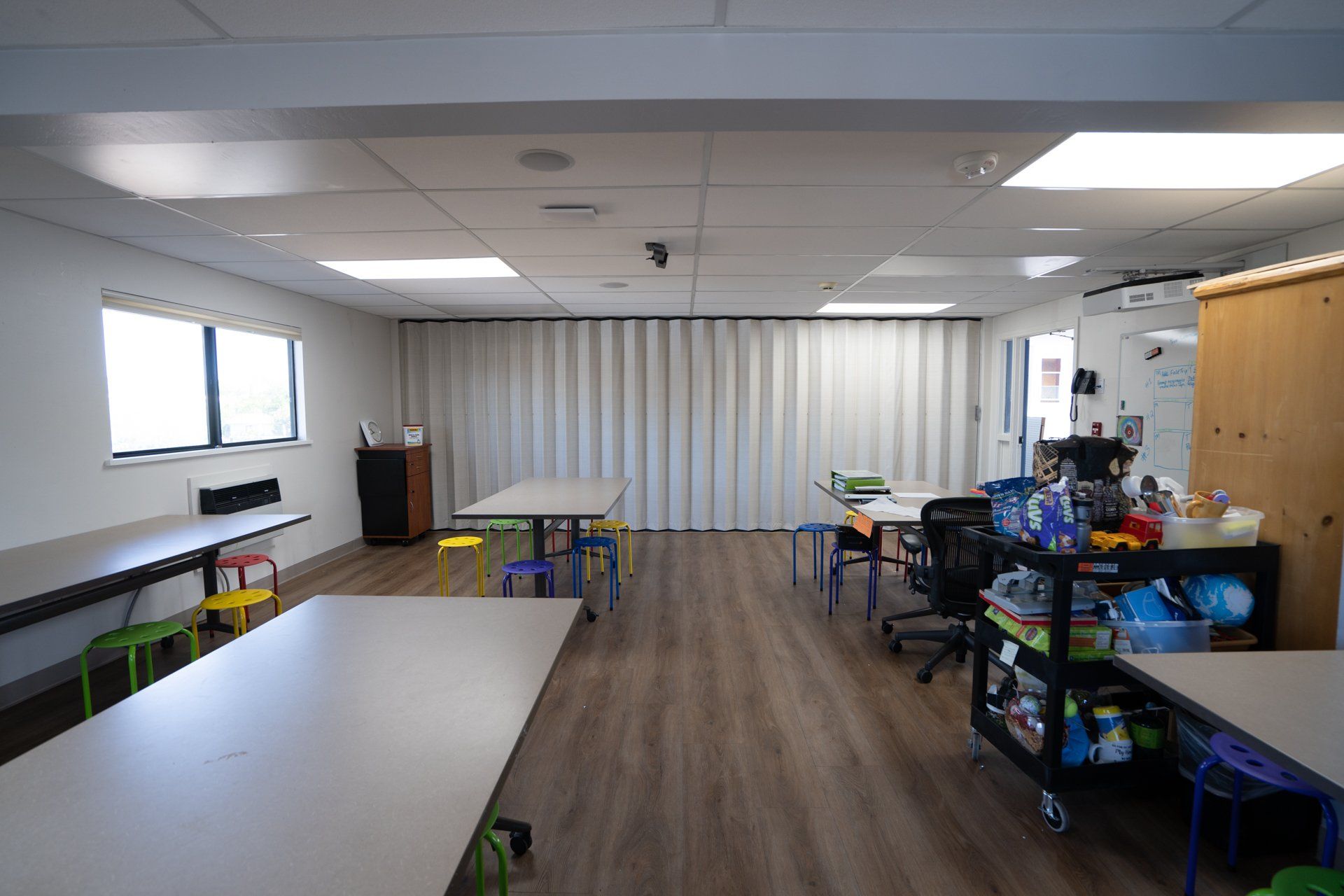 A large room with tables and chairs in it.