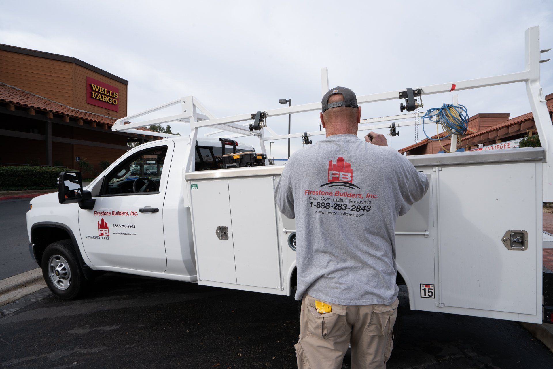 A man is standing in front of a white truck.